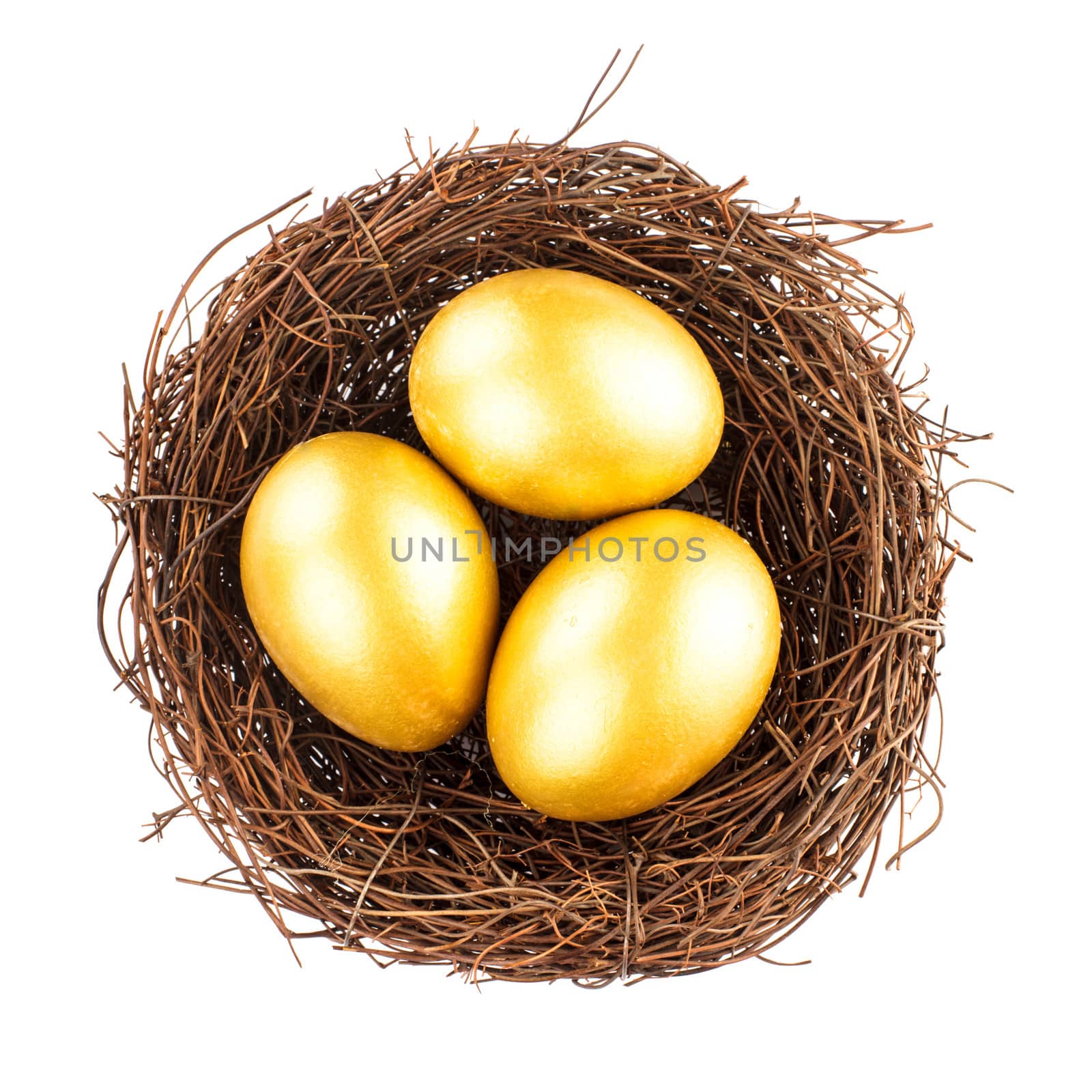 Three golden eggs in the nest isolated on white