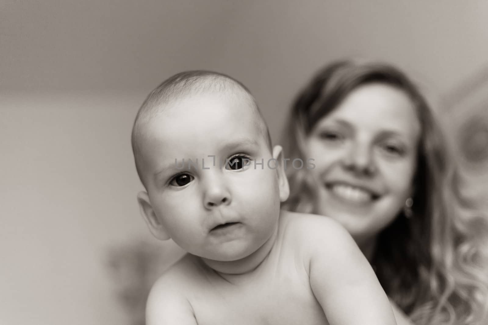 Mother is  playing with her baby son