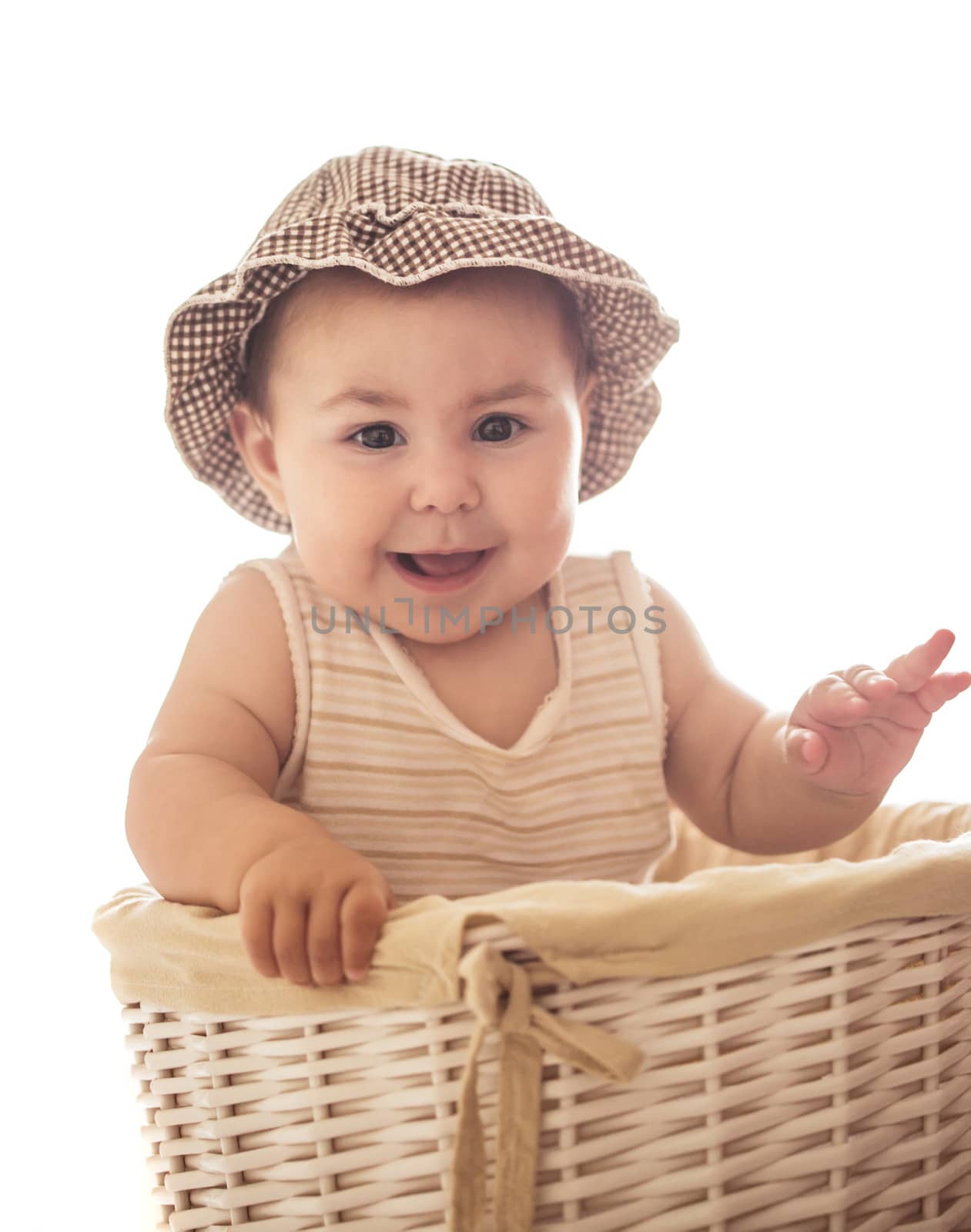 Eight month baby girl play with laundry basket, isolated on white
