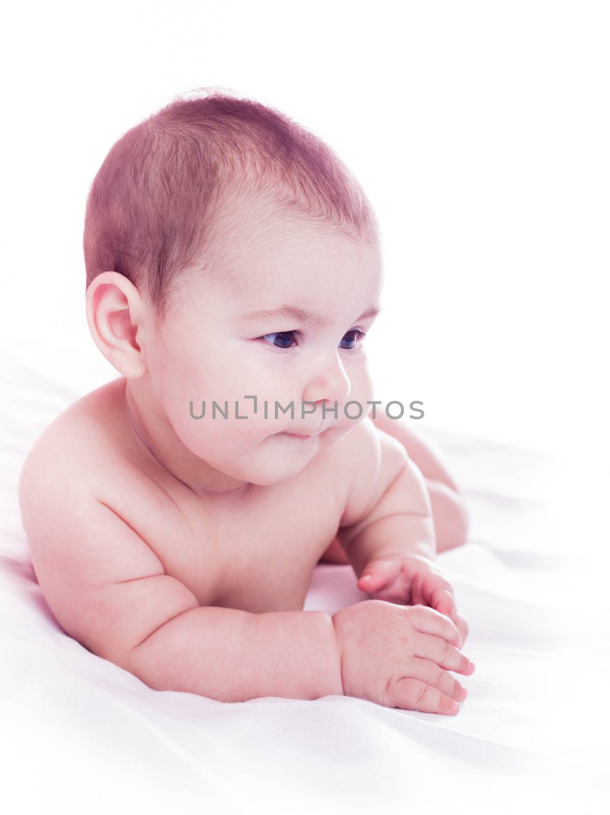 Five month old baby lie and look. Isolated on white