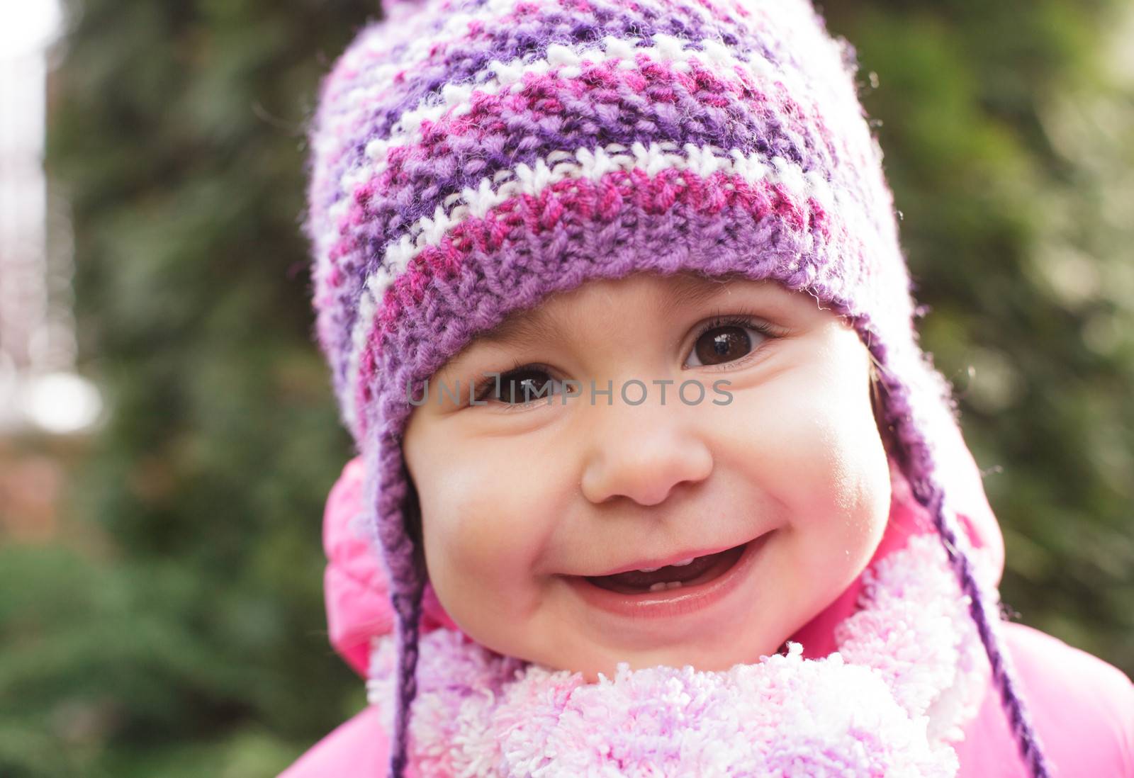 Girl's face with cute smile closeup, outdoors
