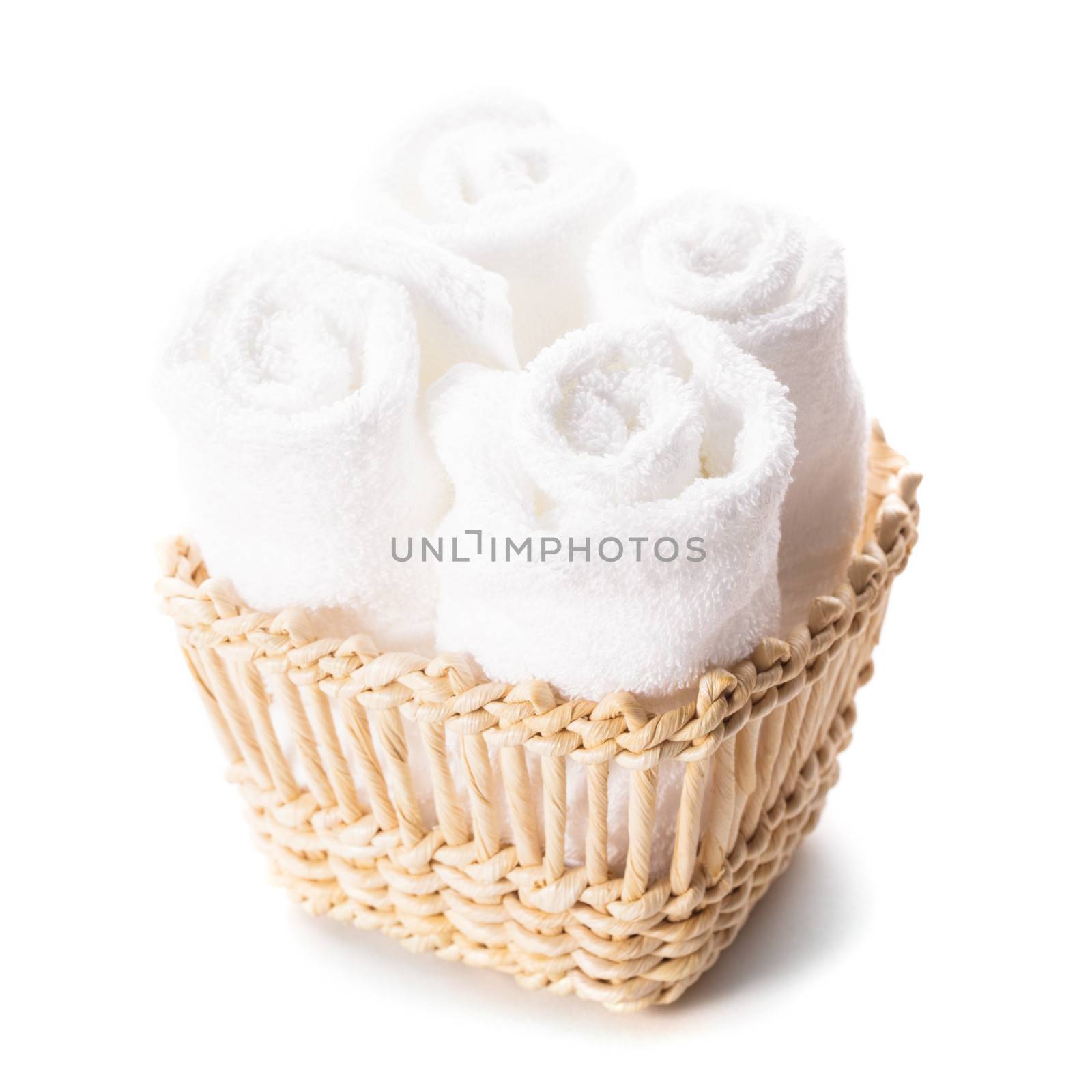 White spa towels pile in a basket isolated