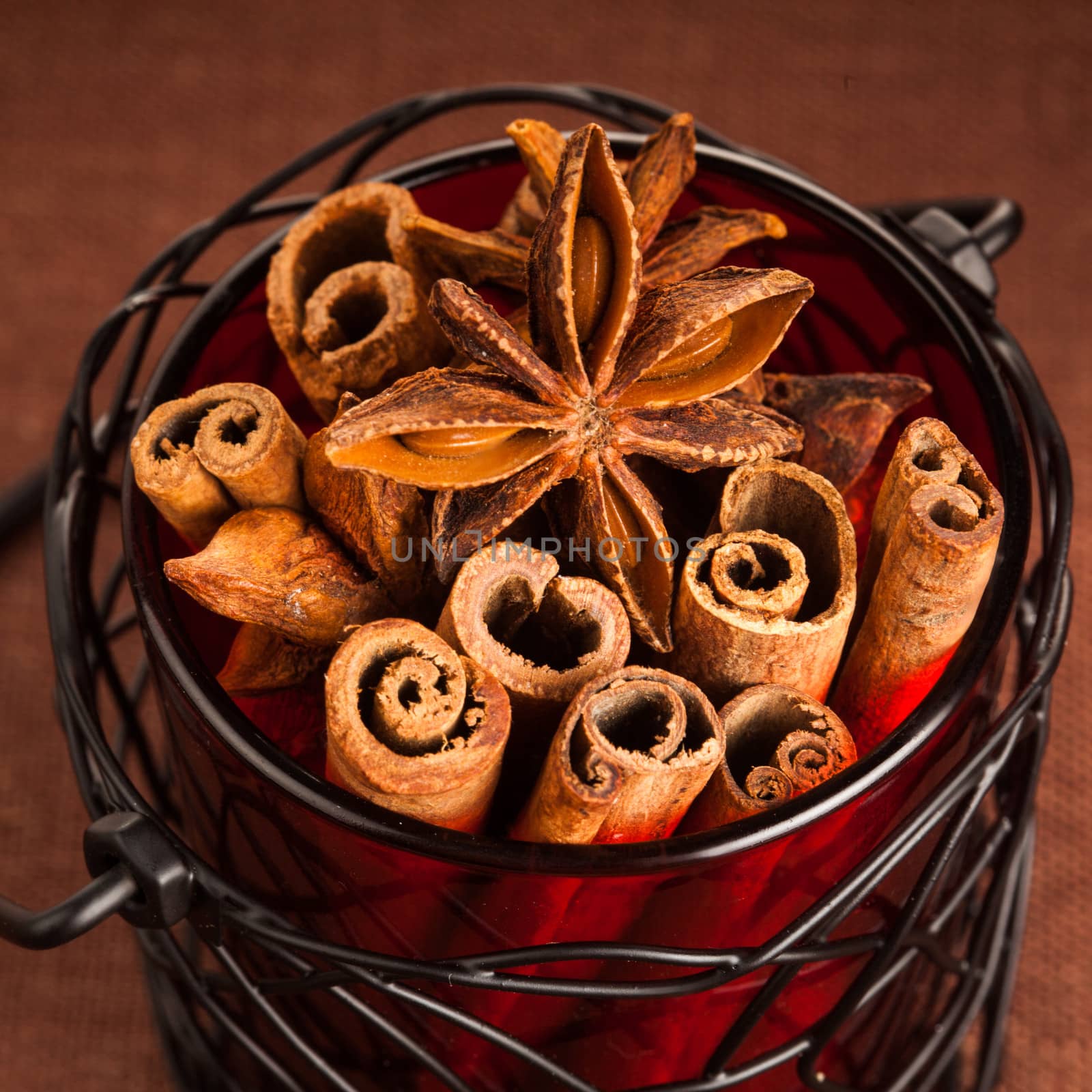 Cinnamon sticks and anise stars in pot. Spices decor for holidays