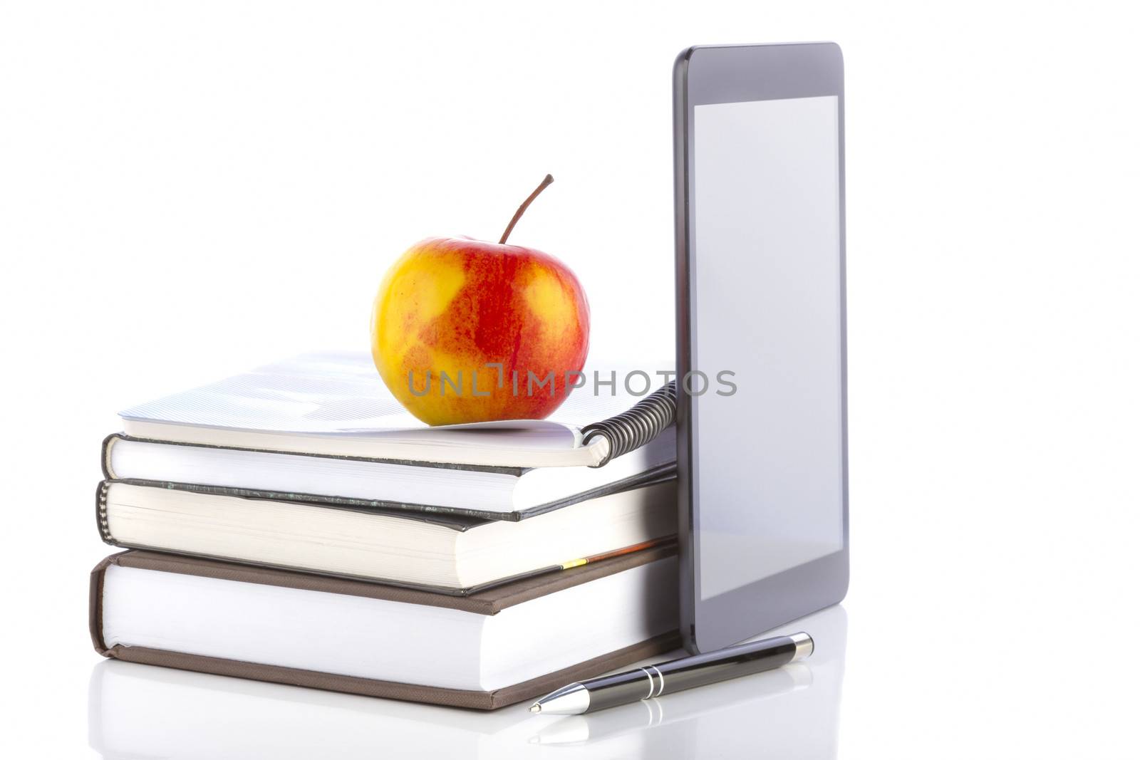 Concept of online education. Tablet pc with school and office supplies.