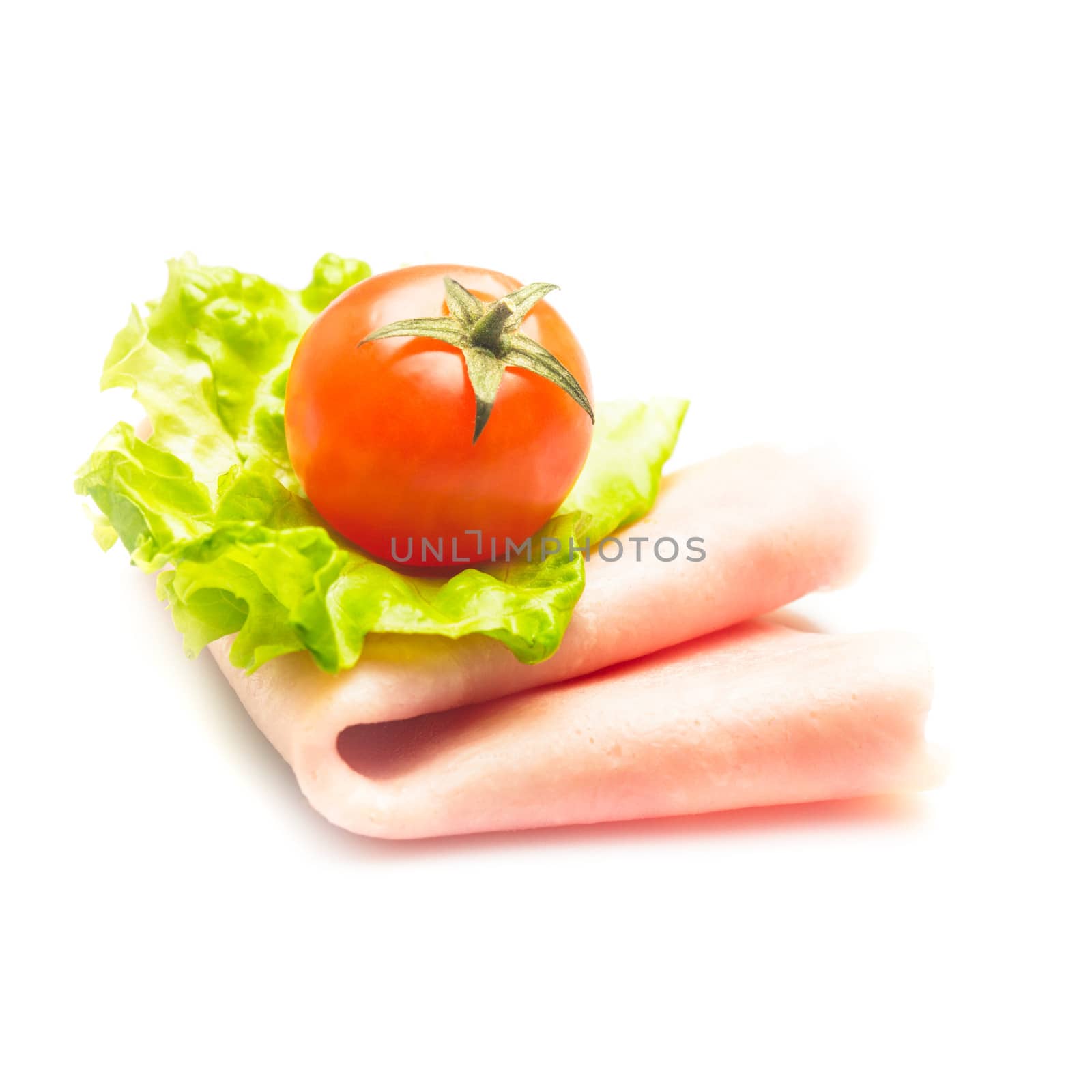 Fresh rolled ham slice and lattuce with cherry tomato isolated on white