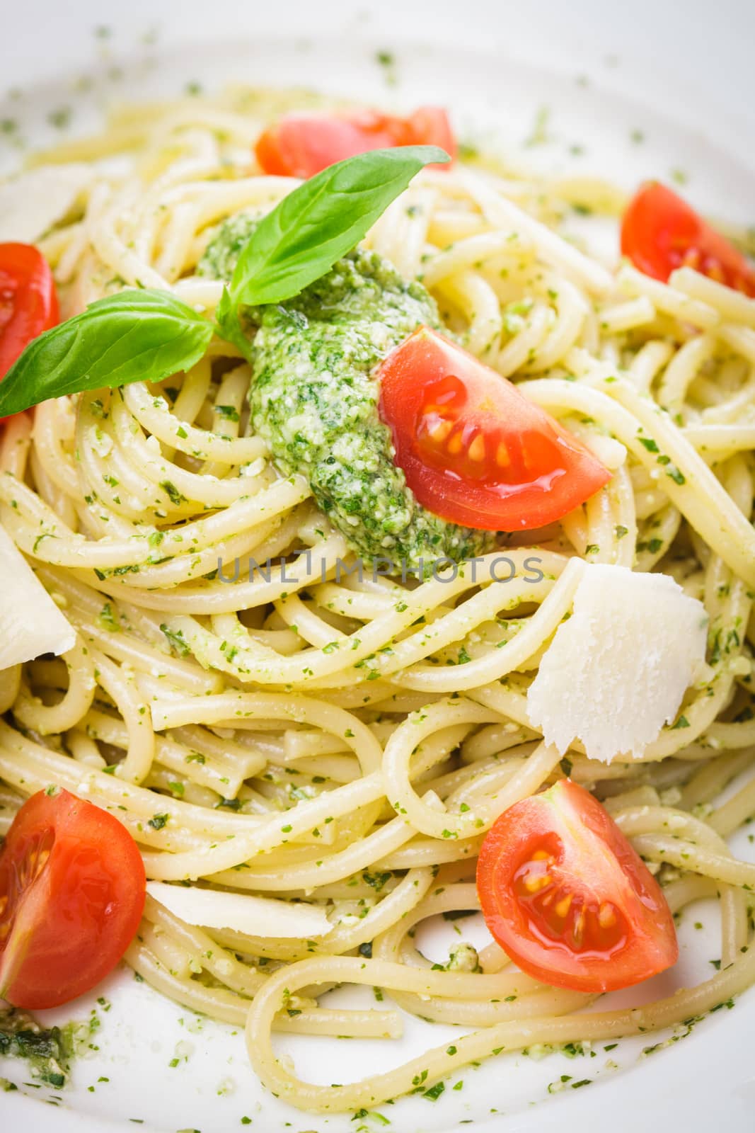 Spaghetti with green pesto, parmesan and cherry tomatoes