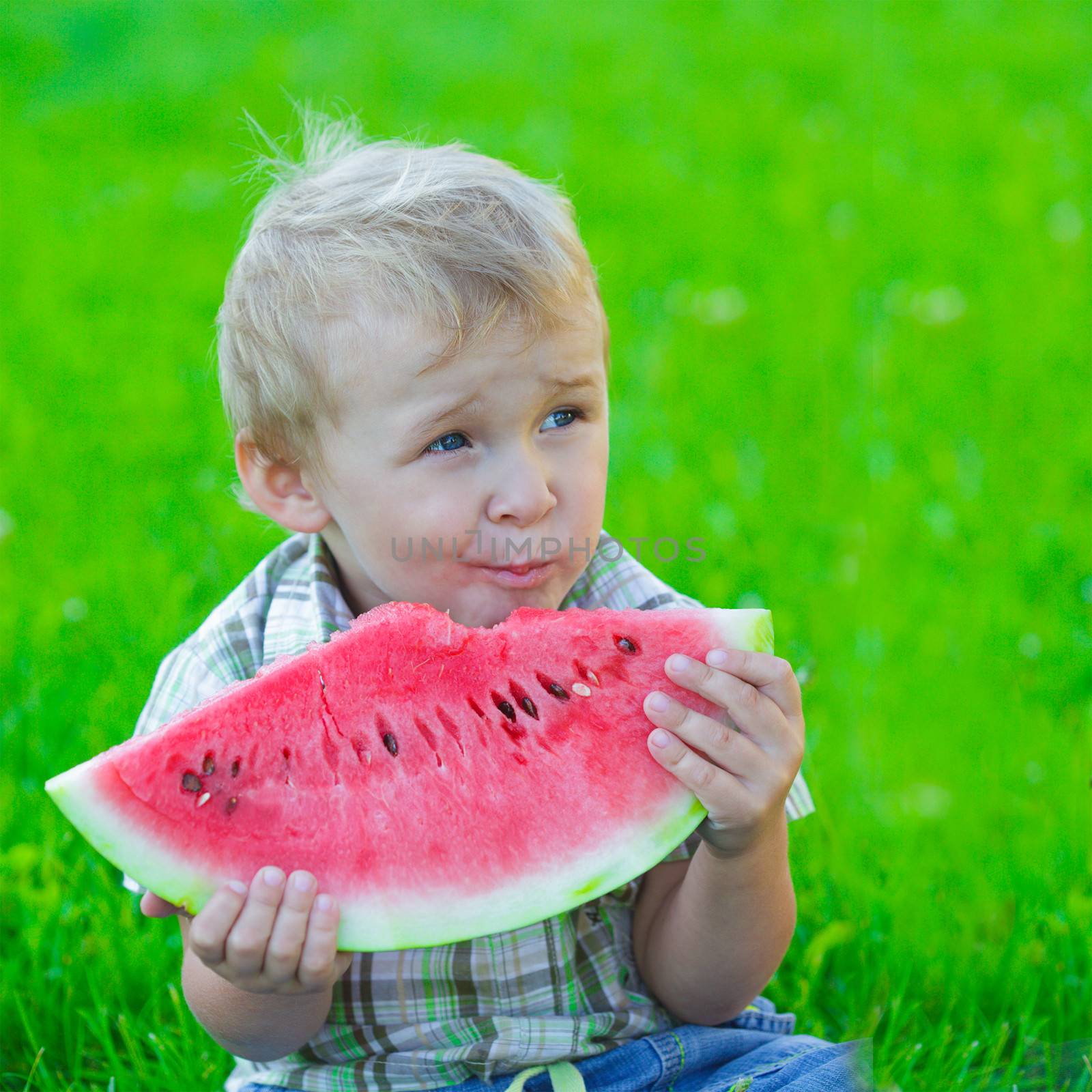Kid with slice of watermelon, outdoors eating, picnic