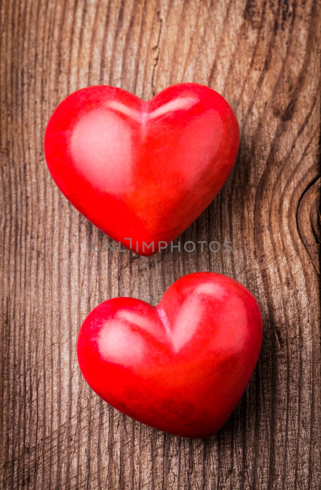 Red hearts on wood by oksix