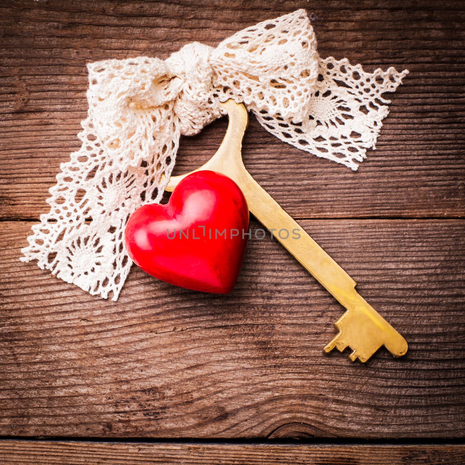 Old intage key and red heart. Key of my heart concept. Valentine's day greetings.