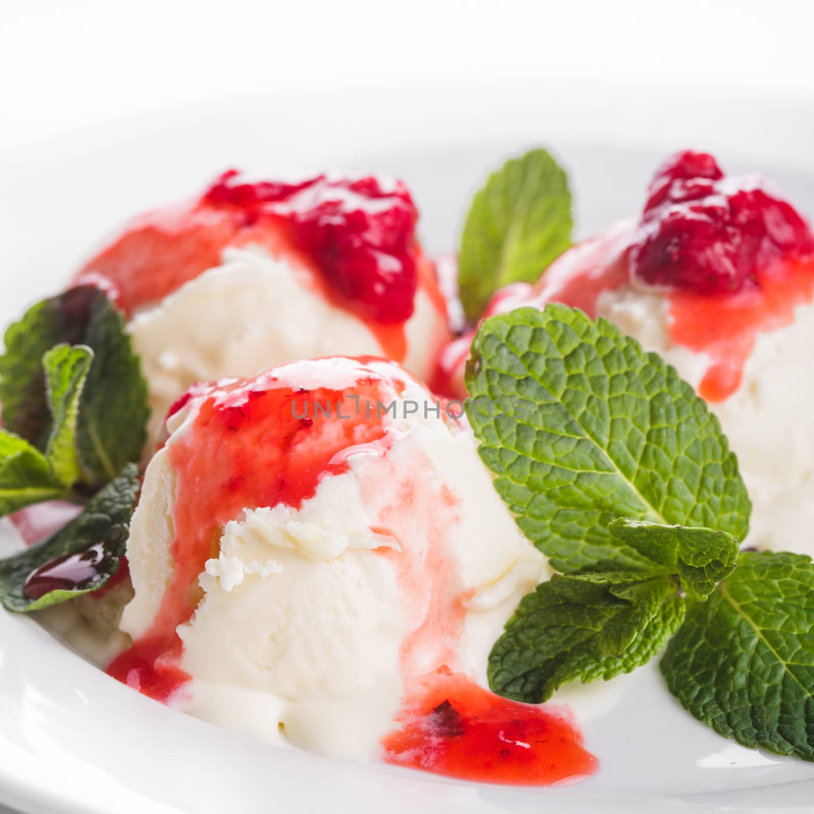 Vanill ice cream with strawberry jam and mint leaves