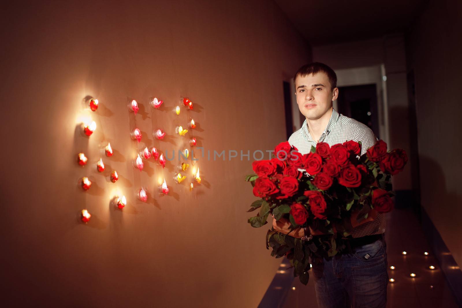 man with  rose bouquet in corridor with 