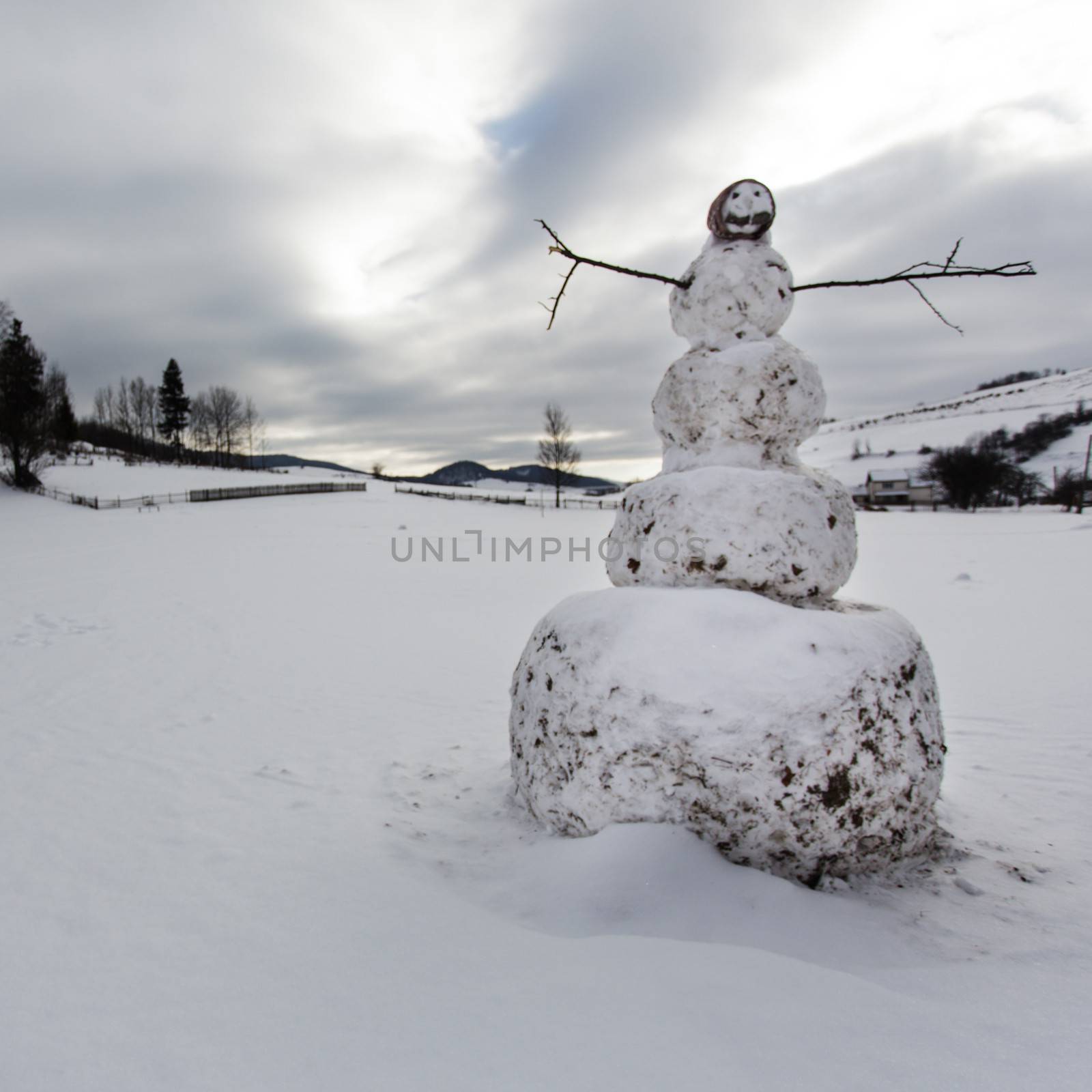 A snowman in the yard in village closeup