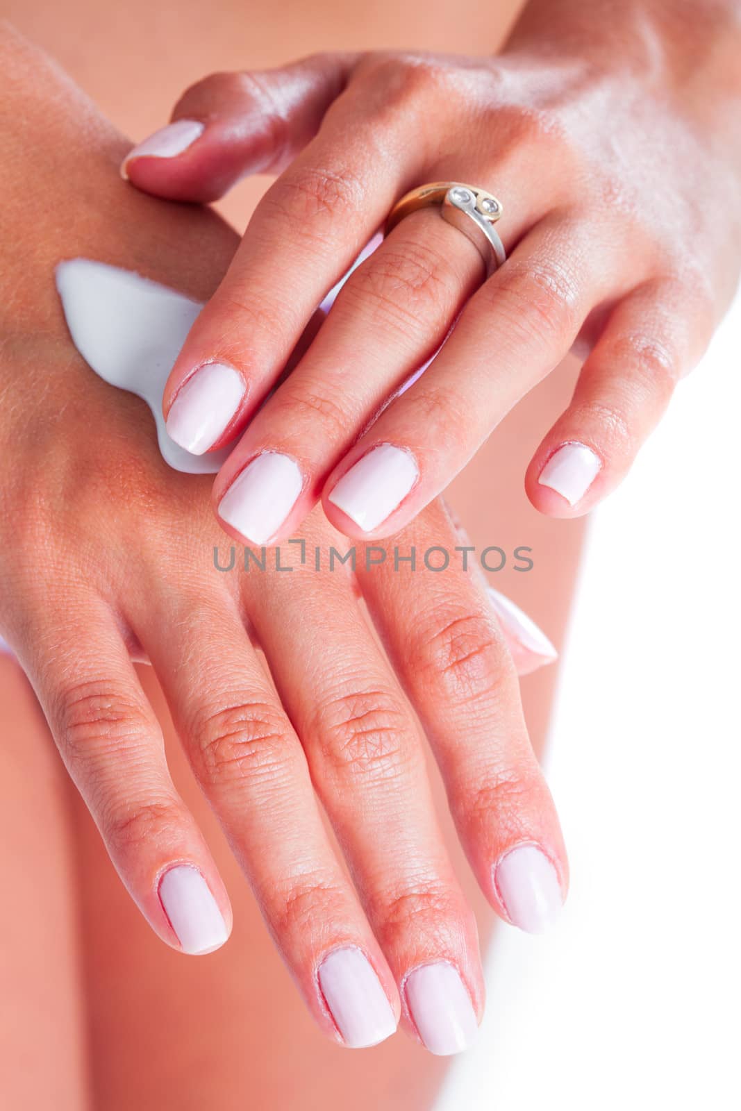 Woman is applaying moisturizing cream for hand care