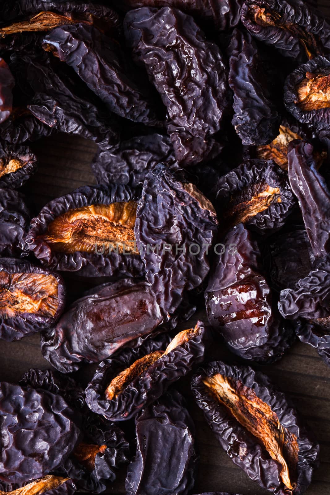 Slices of dried plums closeup on a table