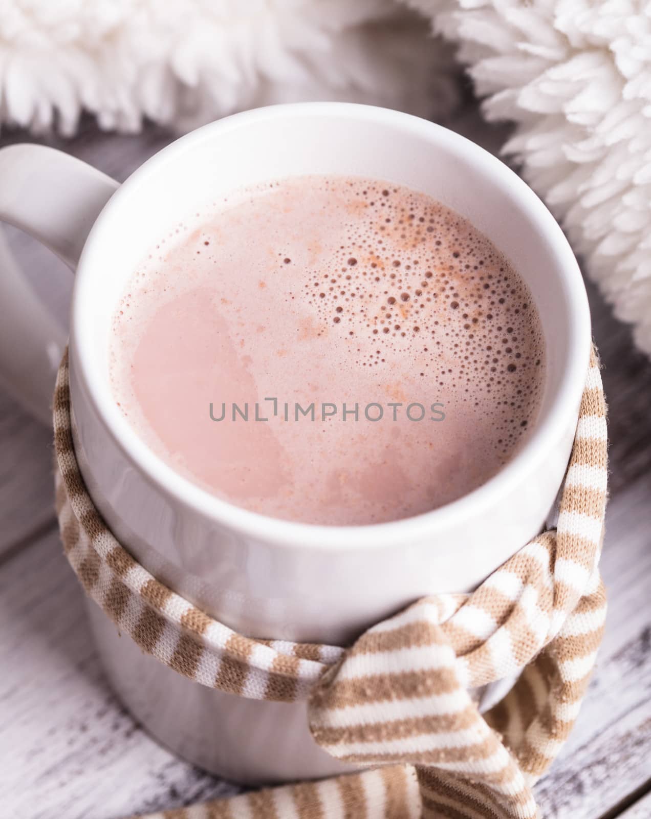 Warming drink - cup of cocoa with milk on the table