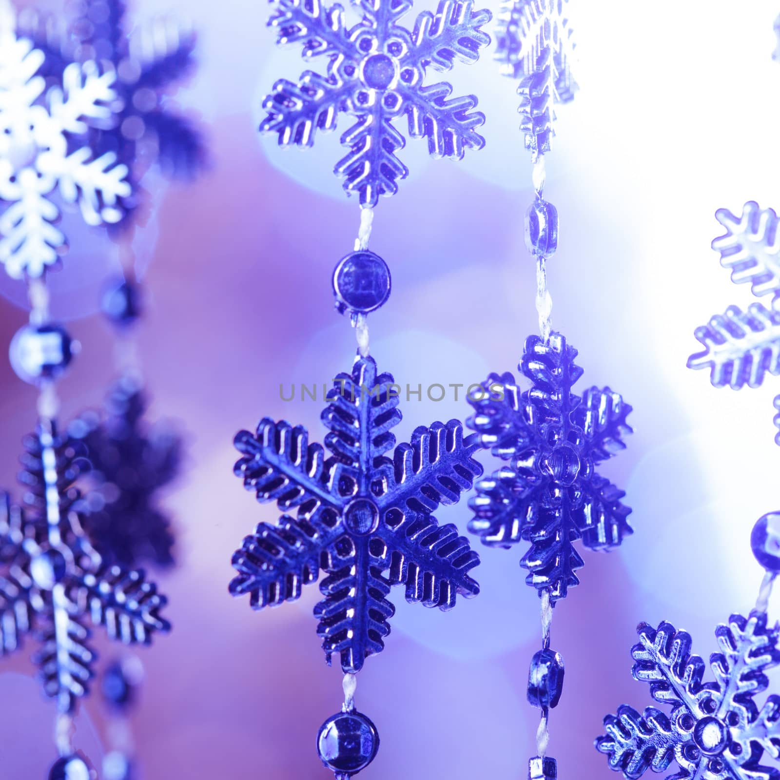 Blue snowflakes on the 
lashing over bokeh background