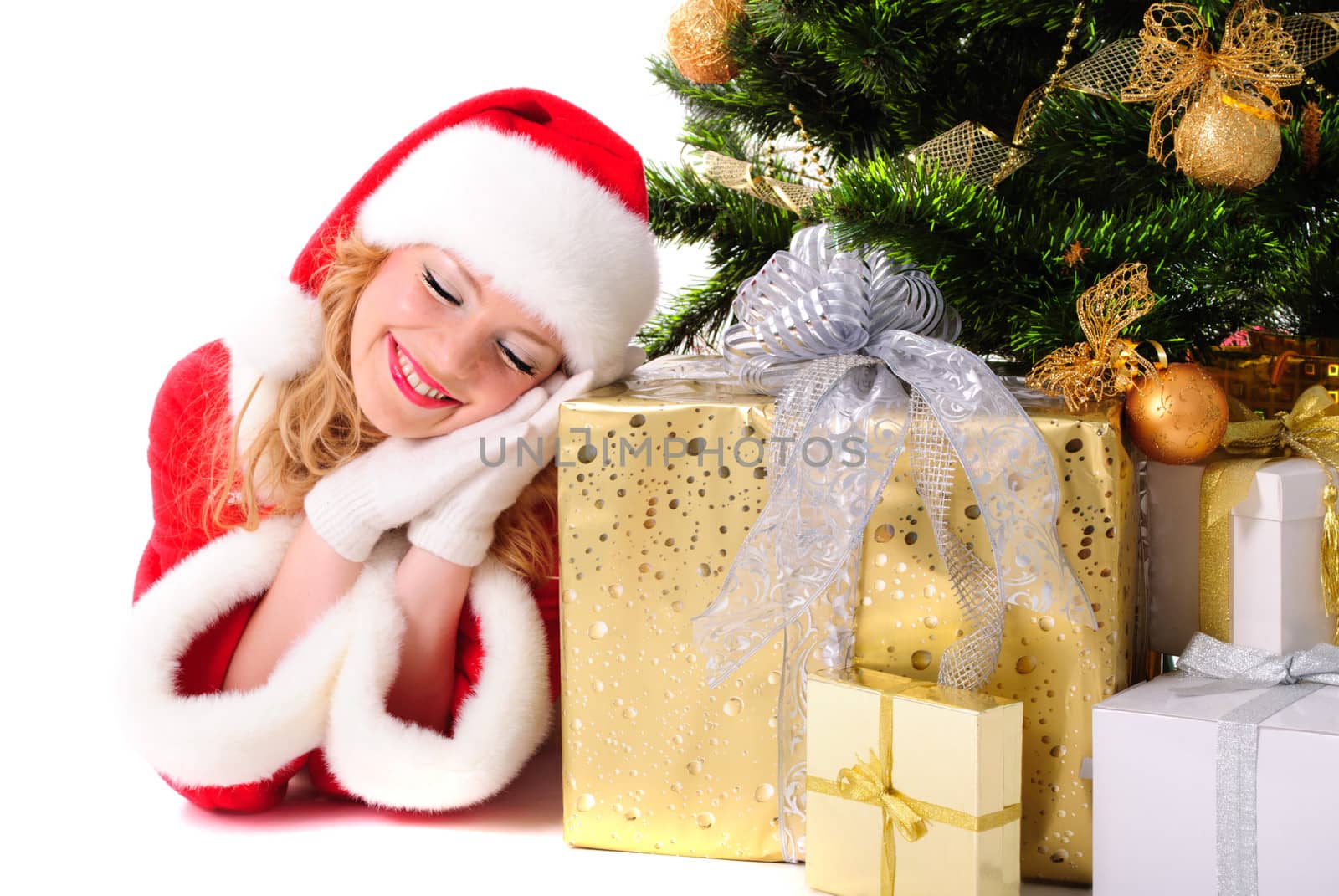 Daydreamed christmas santa girl with gifts and decorated fir-tree.