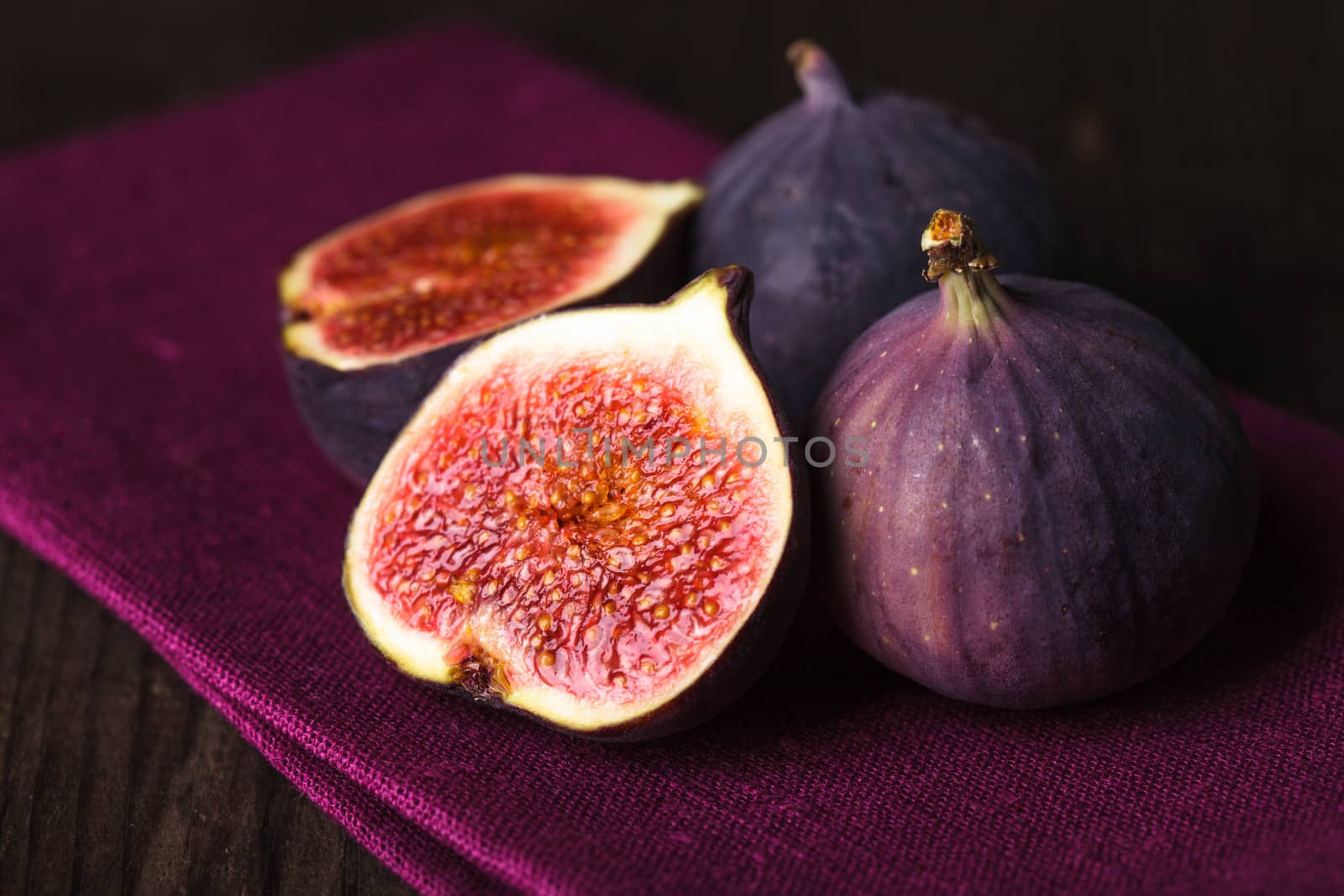 Slice of purple figs on background closeup