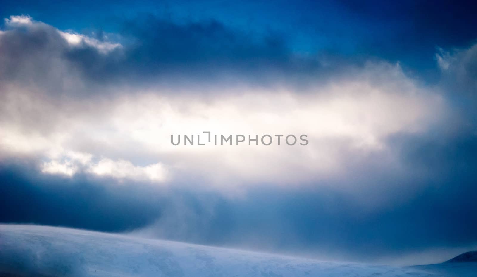 Snowstorm with sunshine high up in the mountains