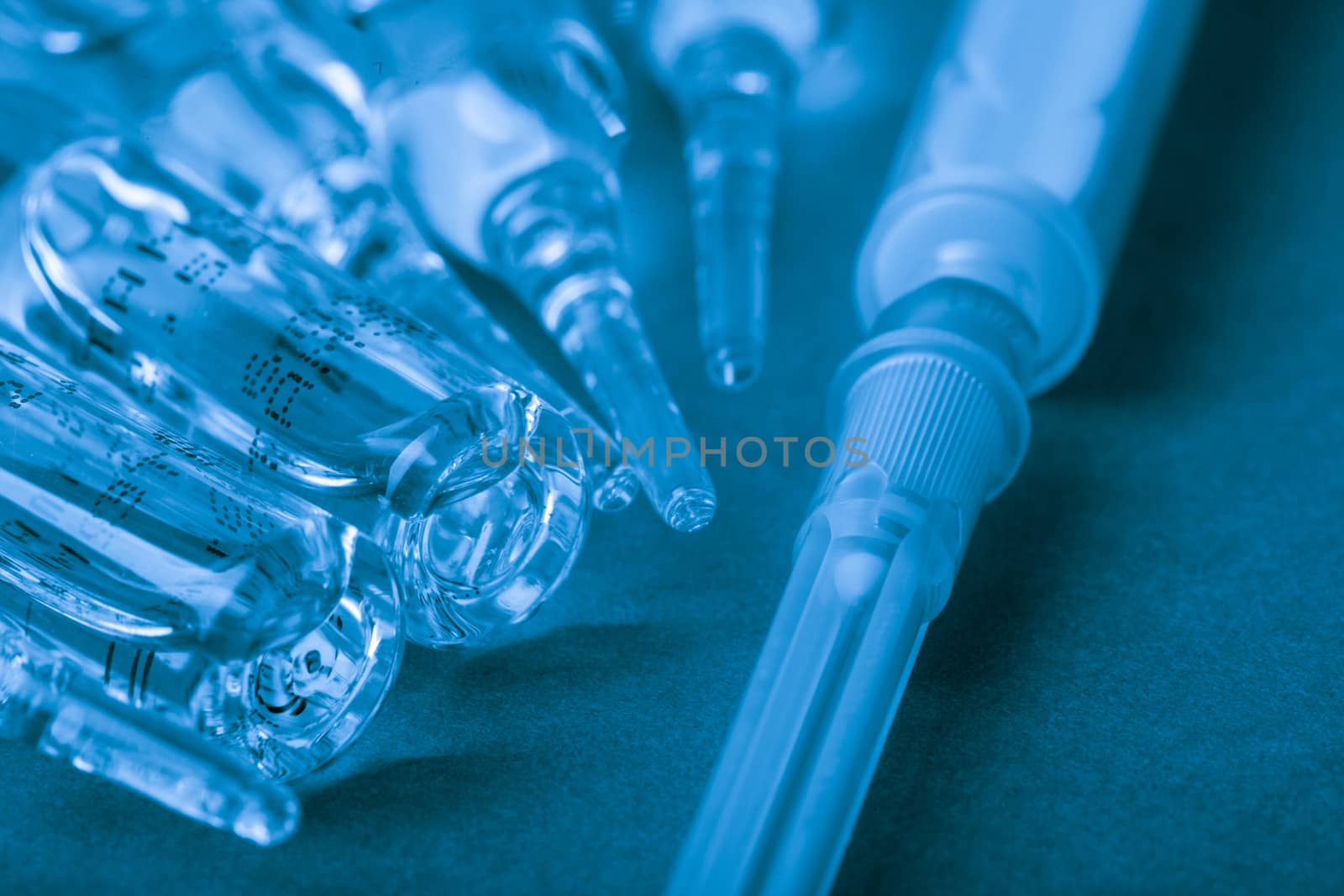 Injection with vaccine closeup on blue background