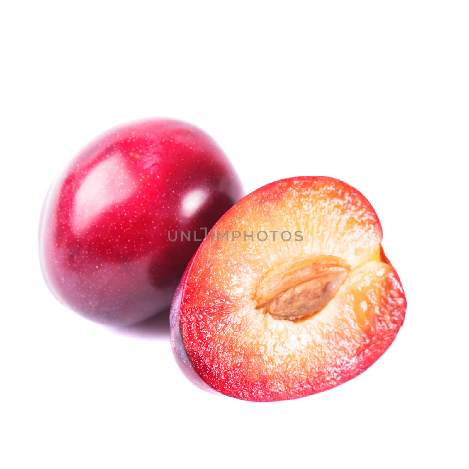 Part of a purple plum isolated on white