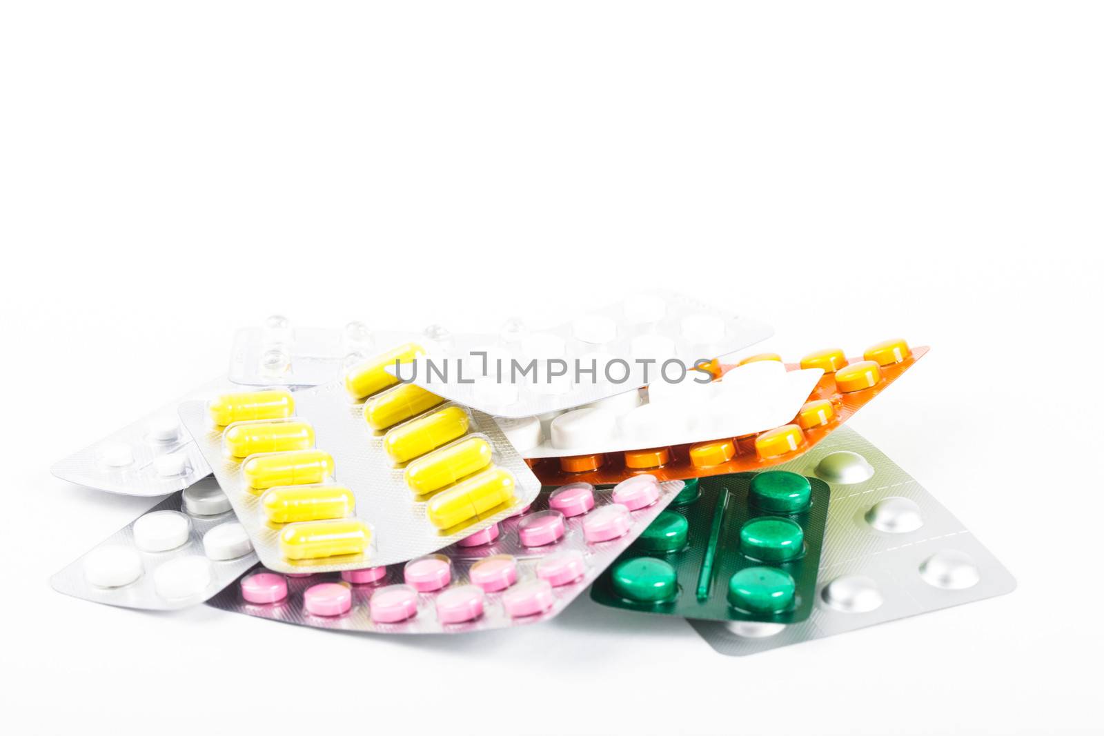 A variety of tablets in packs on white background