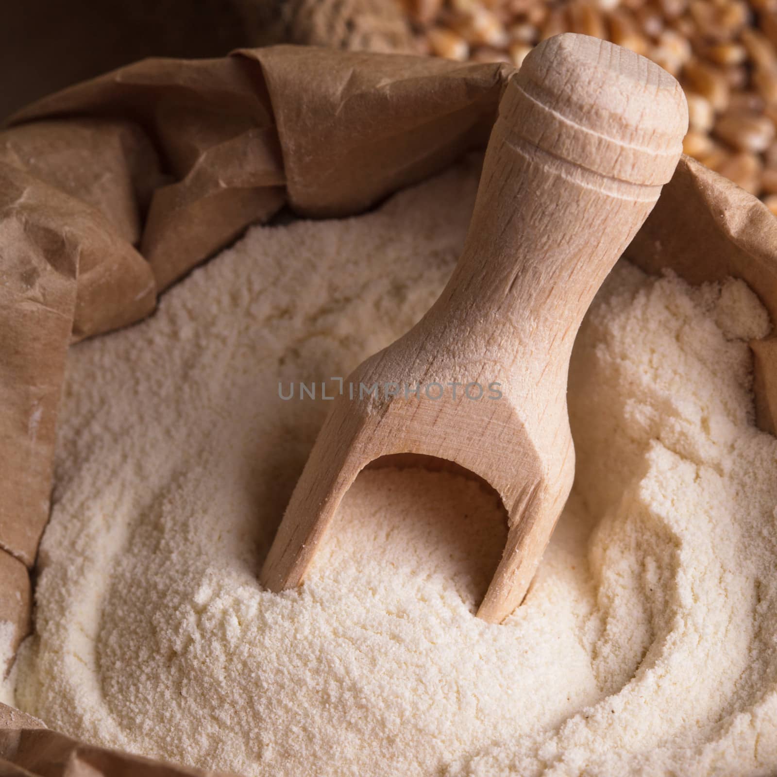 Meal in sack with wooden spoon closeup