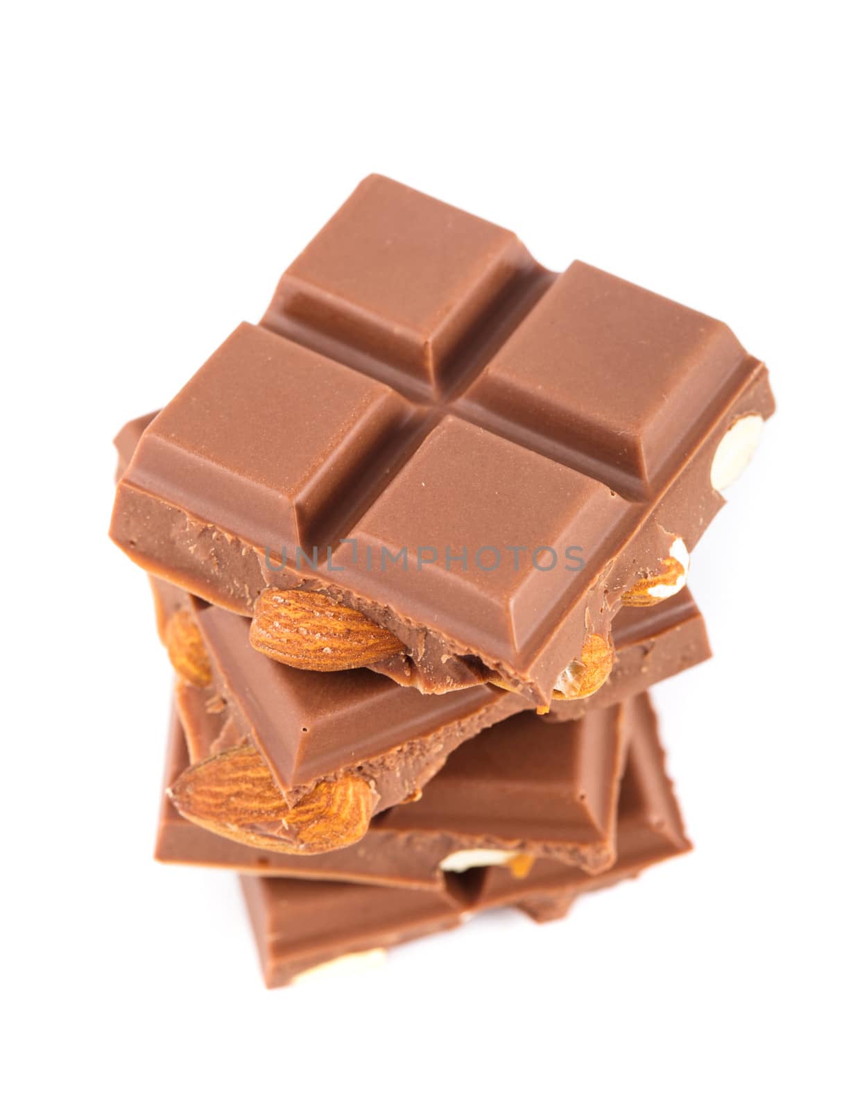 Tile milk chocolate with almonds closeup on white