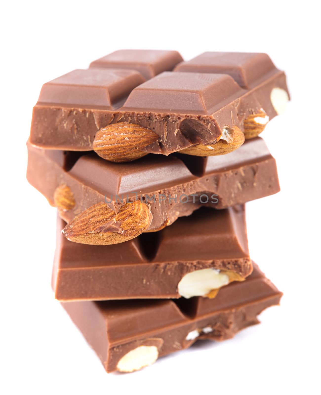 Tile milk chocolate with almonds closeup on white