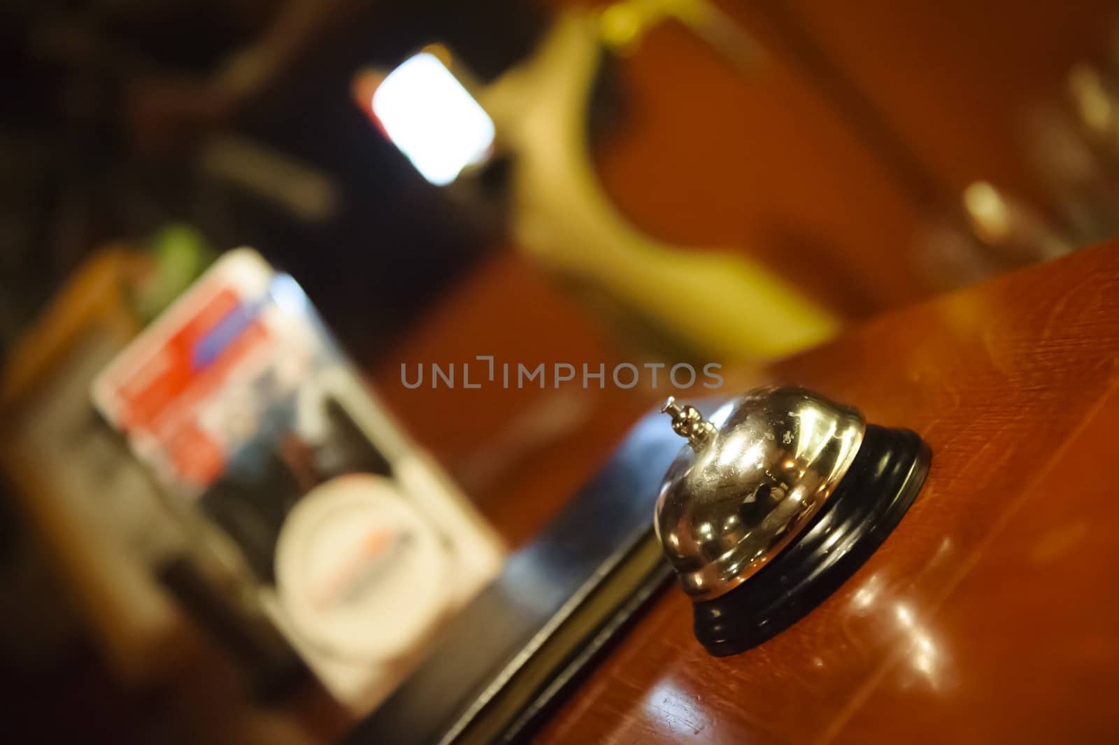 Silver metallic bell on the brown in the hotel  reception or restaurant, shallow DOF.