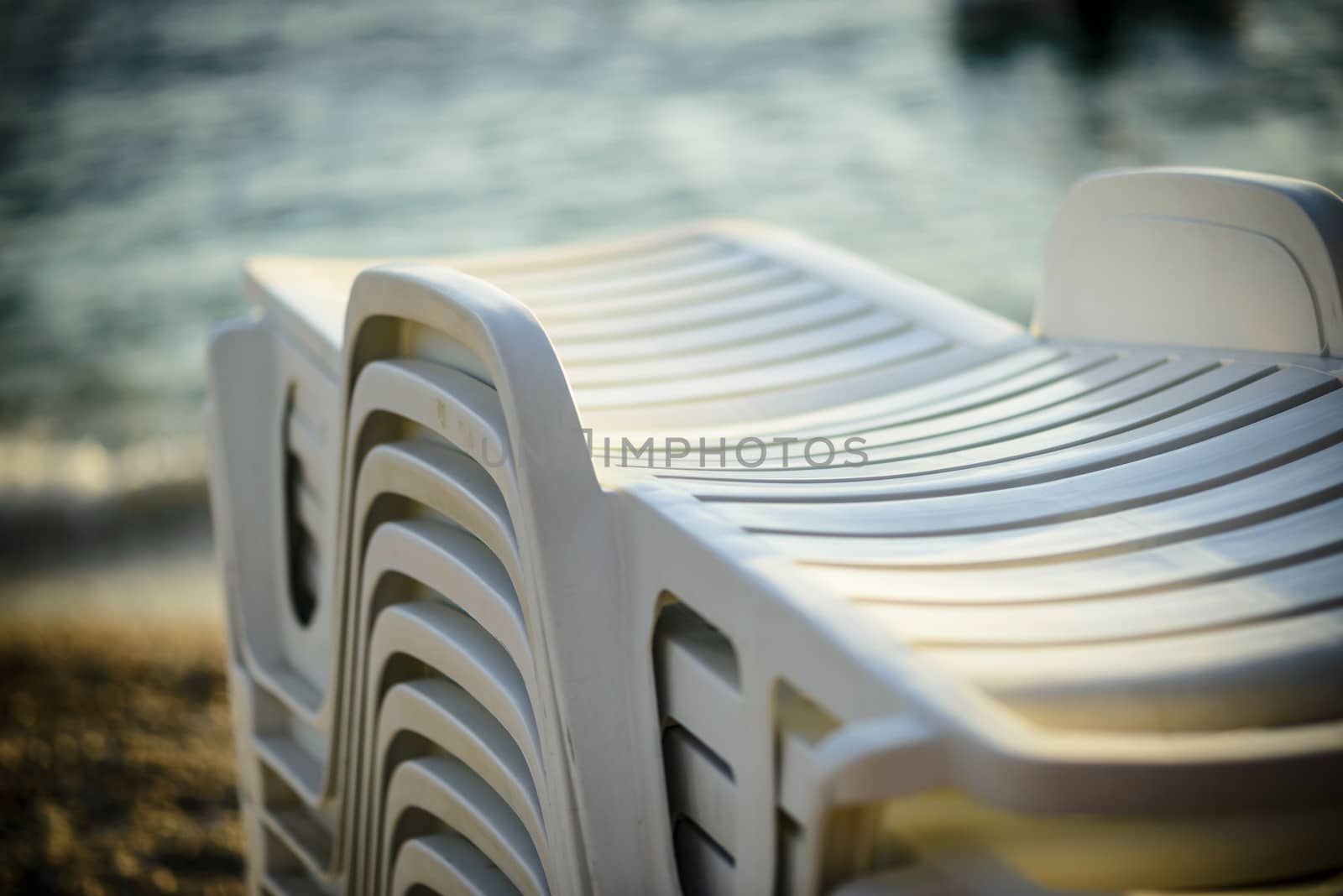 Deckchairs ready for use, visible sea, shallow DOF. by westernstudio