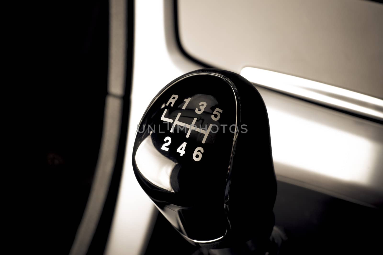 Interior of car, vehicle with visible lever of manual  transmission, with metal, chrome elements.