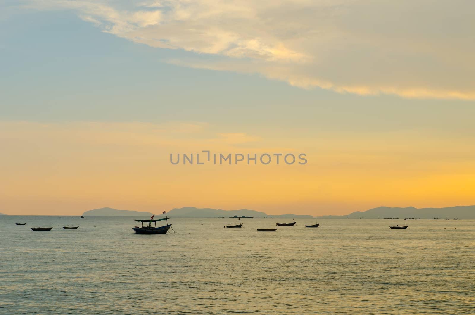 Small fishing boats anchor near bay by tamnongthai
