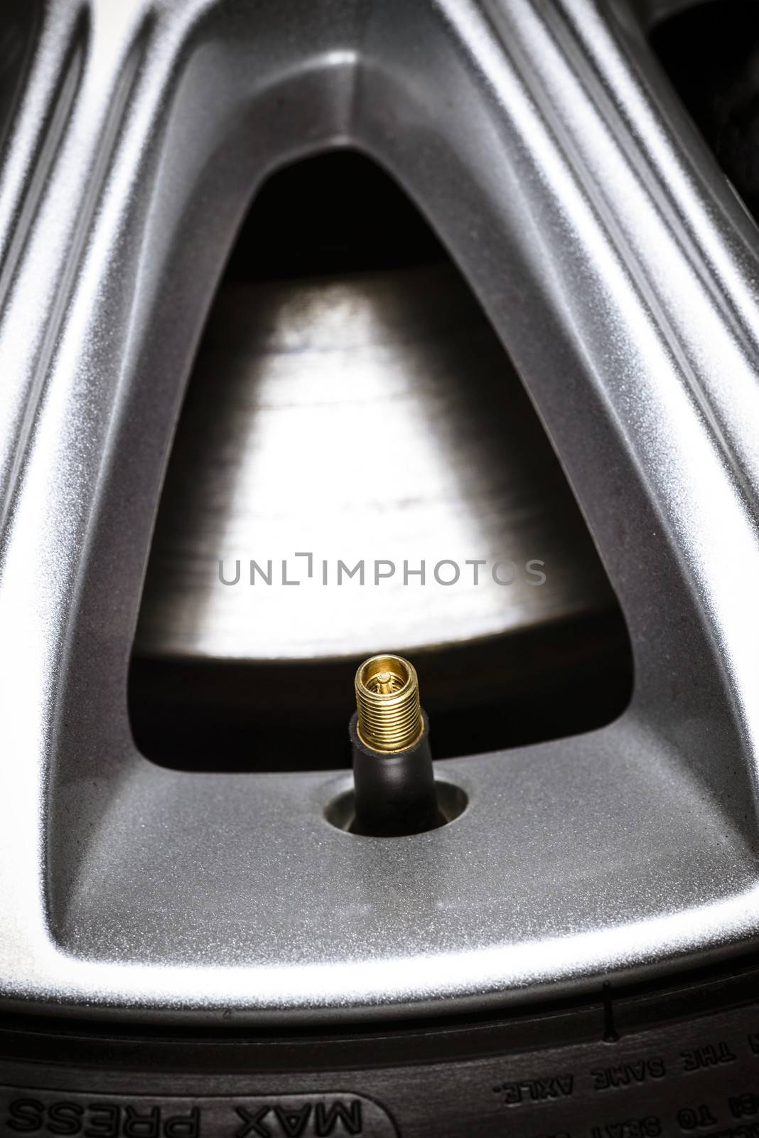 Close-up of a tire valve on car wheel. by westernstudio