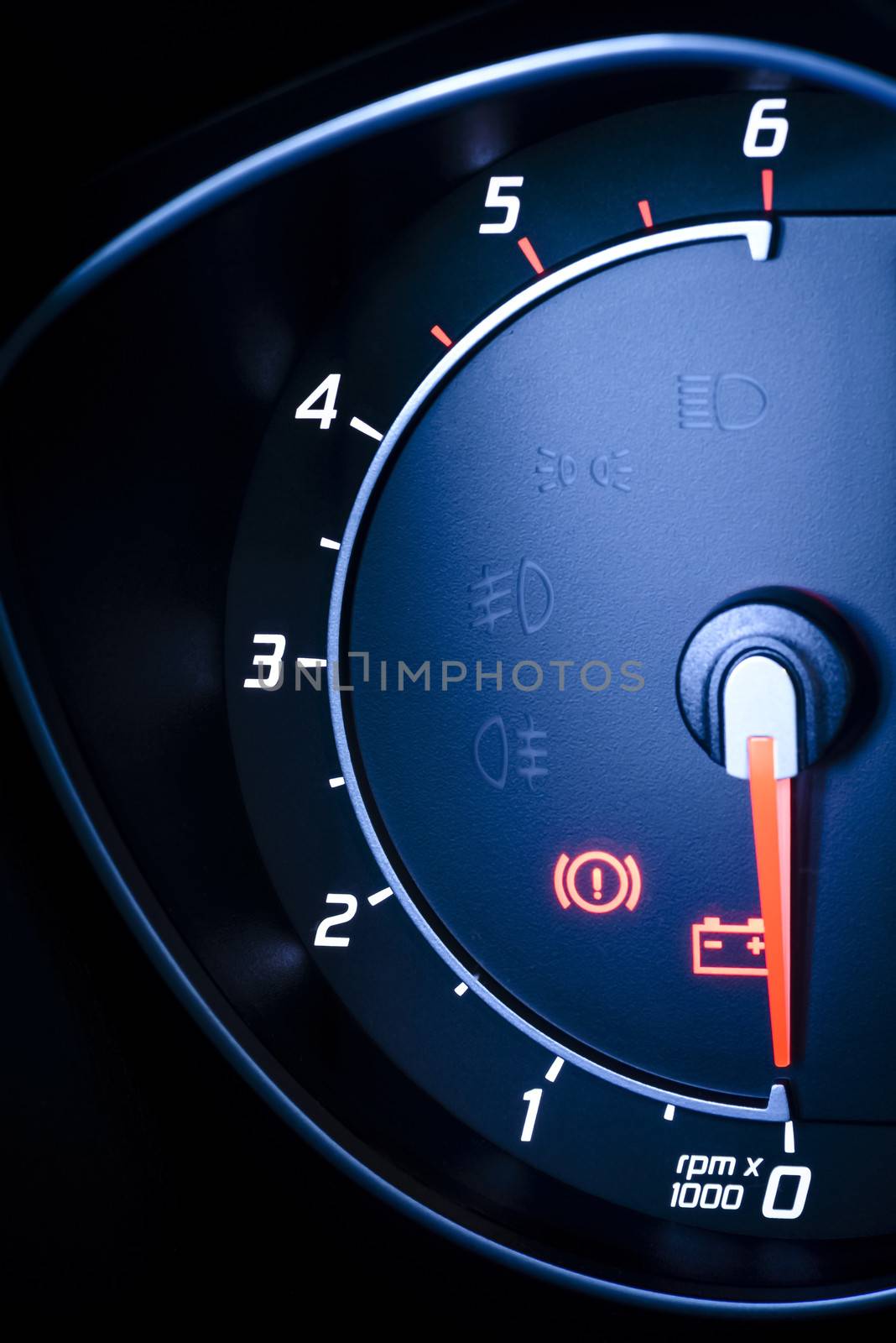 Fragment of instrument panel of car speedometer, tachometer with visible symbols of instrument cluster, with warning lamps illuminated. by westernstudio