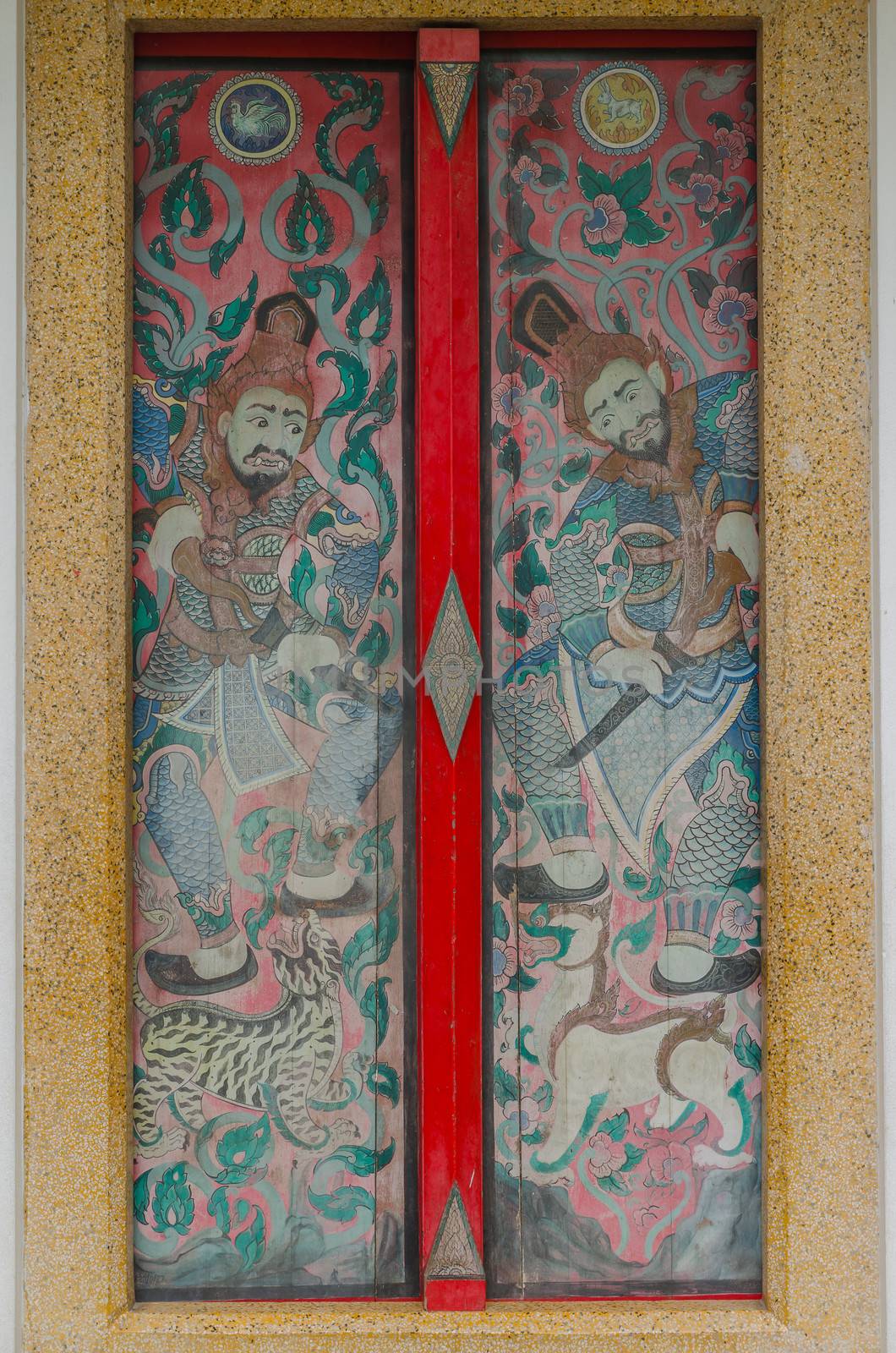 Thai and chinese art paint mural on multi colors door in thai temple at Chonburi Thailand
