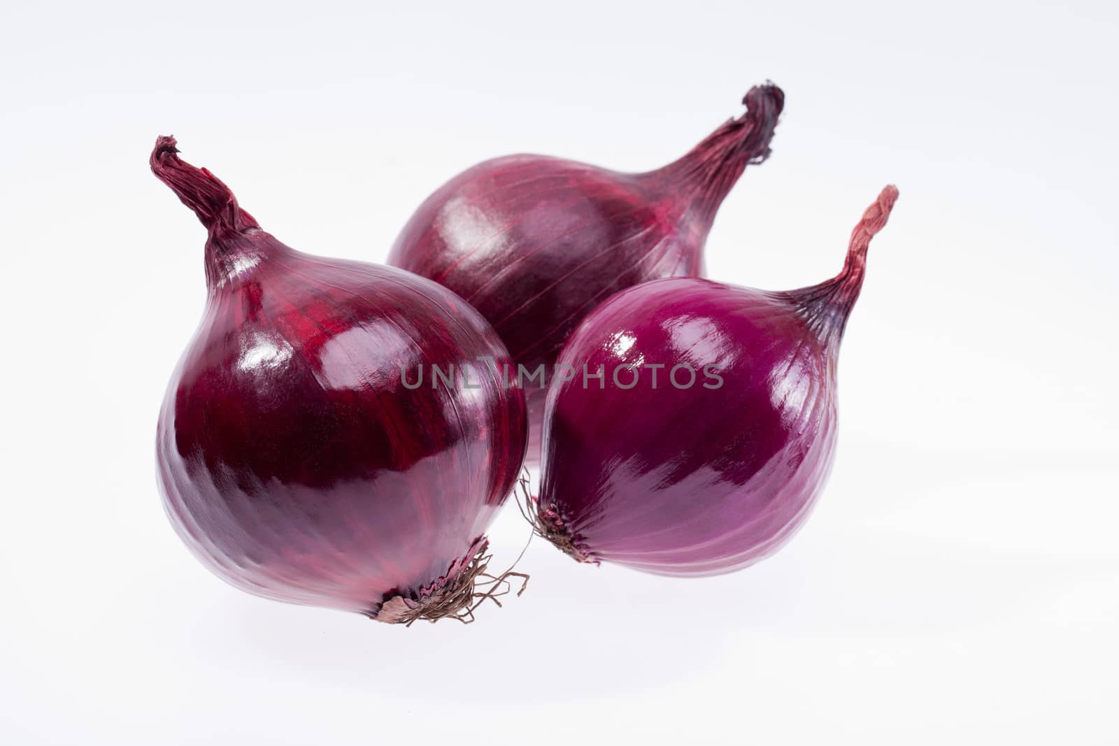 group of red onions isolated on white background closeup