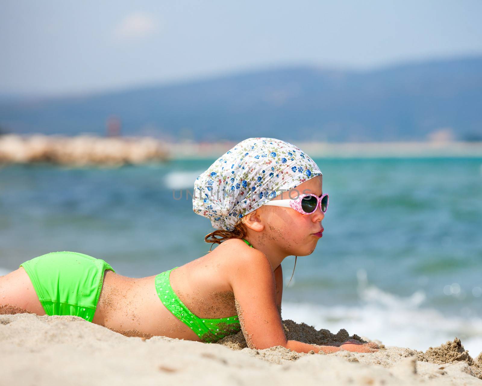 Little girl enjoying summer day on a beach