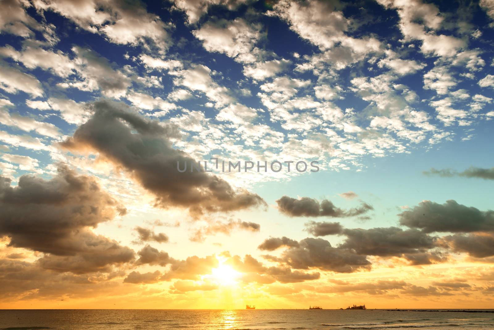 Sunrise with sun rays and clouds