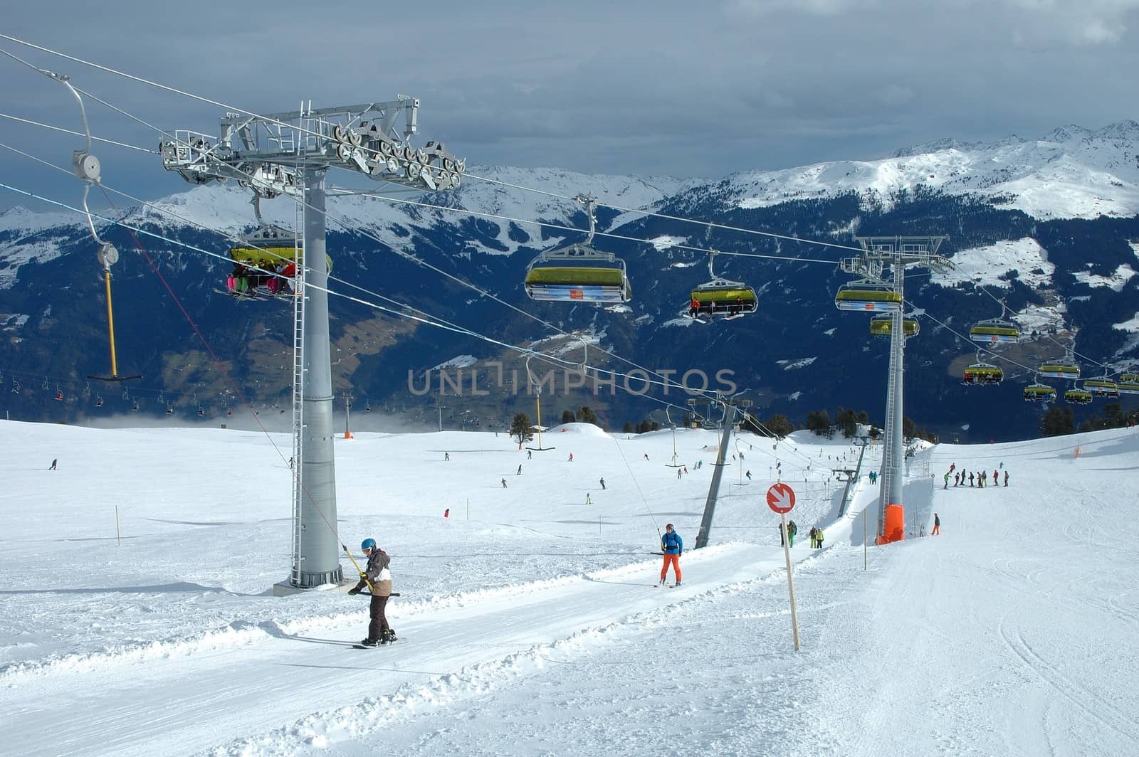 Kaltenbach, Austria - February 04: Ski lifts and unidentified skiers on drag and chair lifts nerby nearby Kaltenbach in Zillertal in Austria 04.02.2014