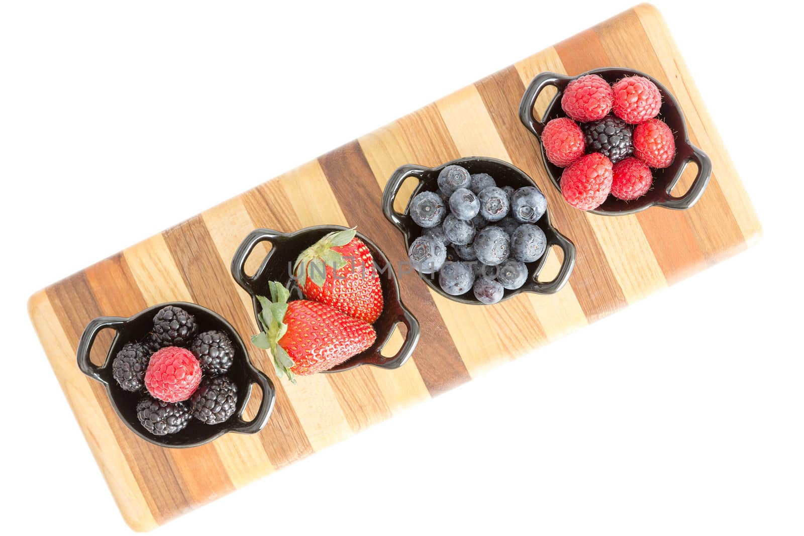 Varieties of fresh berries in individual dishes by coskun