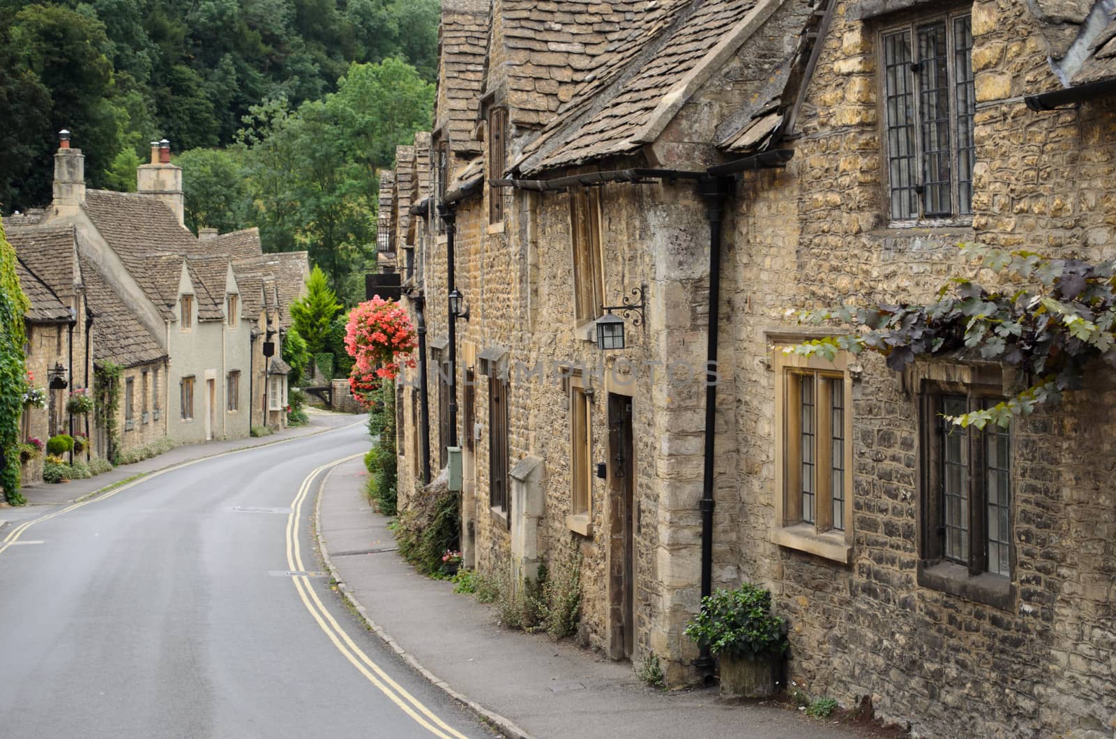 The quaint fairy tale village of Castle Combe at the border between the Cotswolds and Wiltshire with its characteristic old cottages. Rural England at its best.