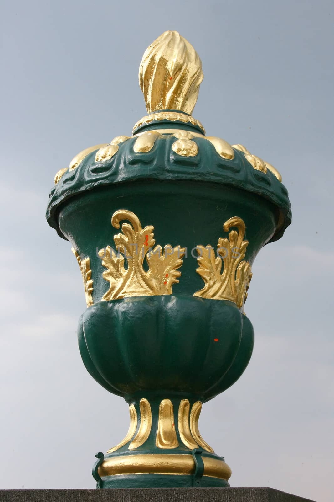 Green and gold vase with lid and ornaments