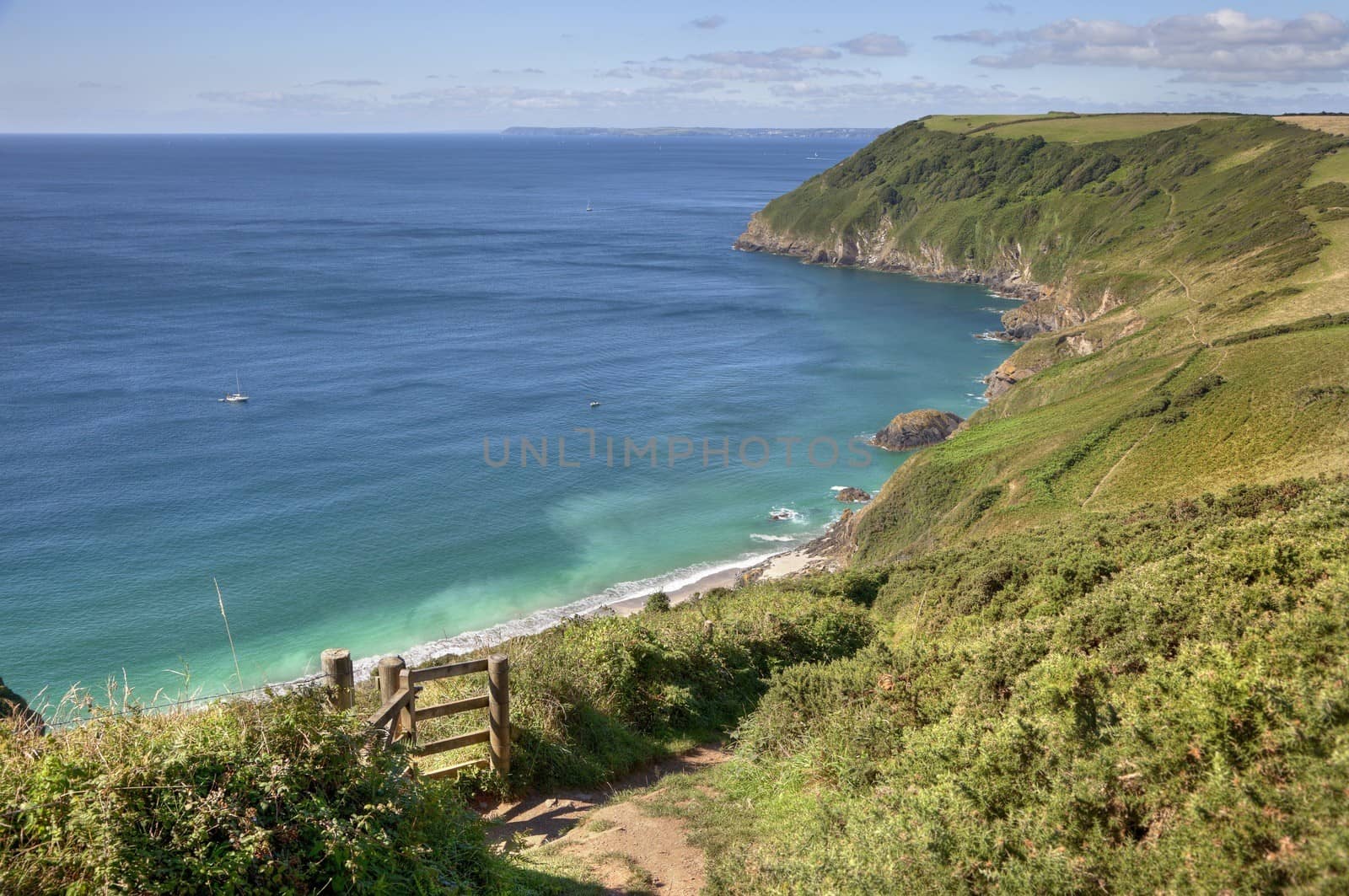 Overlooking the emerald sea at Lantic Bay, Cornwall, England.