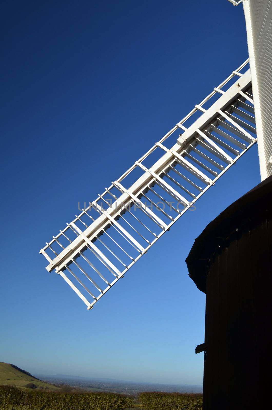 Close view of a traditional English windmill showing one of its sweeps overlooking the South Downs in the County of Sussex,England.