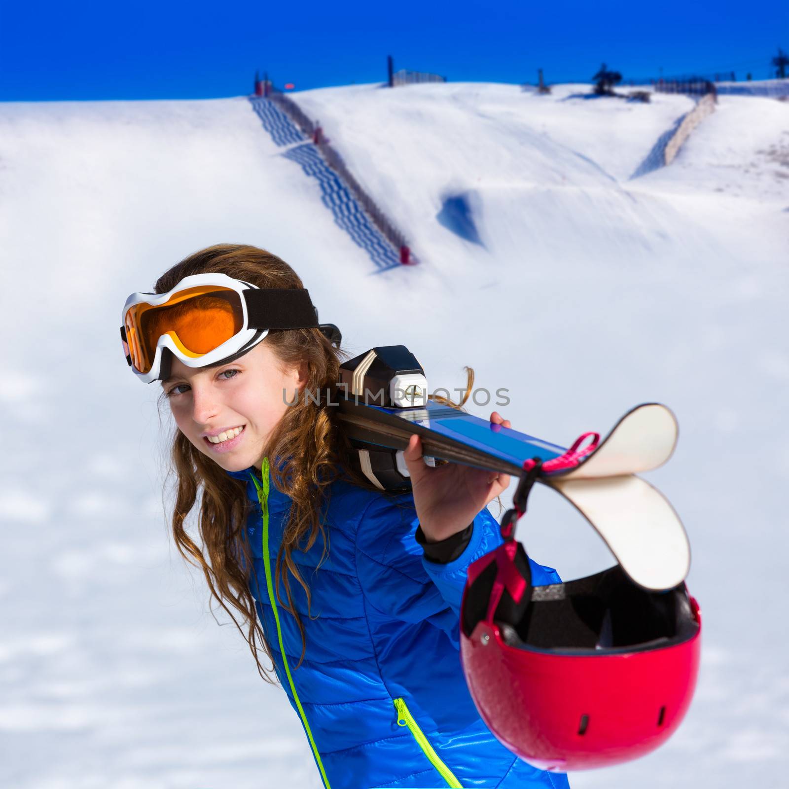 Kid girl winter snow holding ski equipment helmet goggles