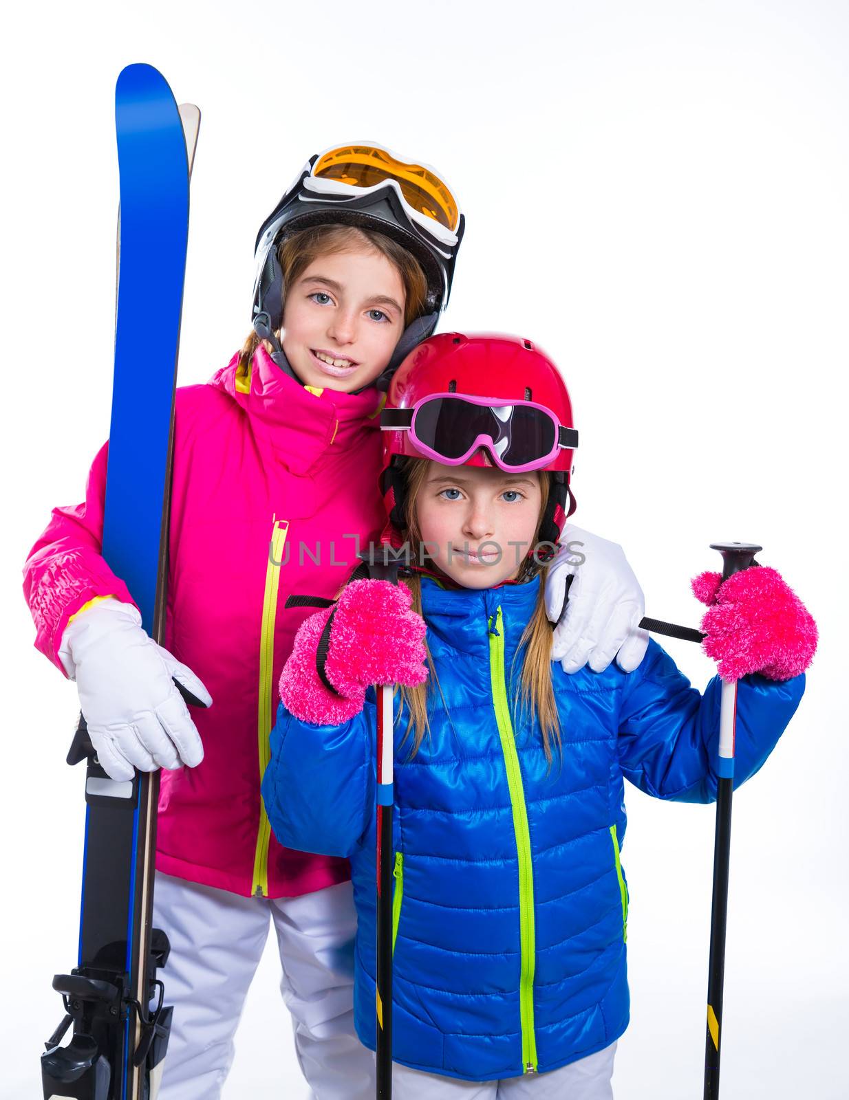 siters kid girls with ski poles helmet and goggles going to winter snow