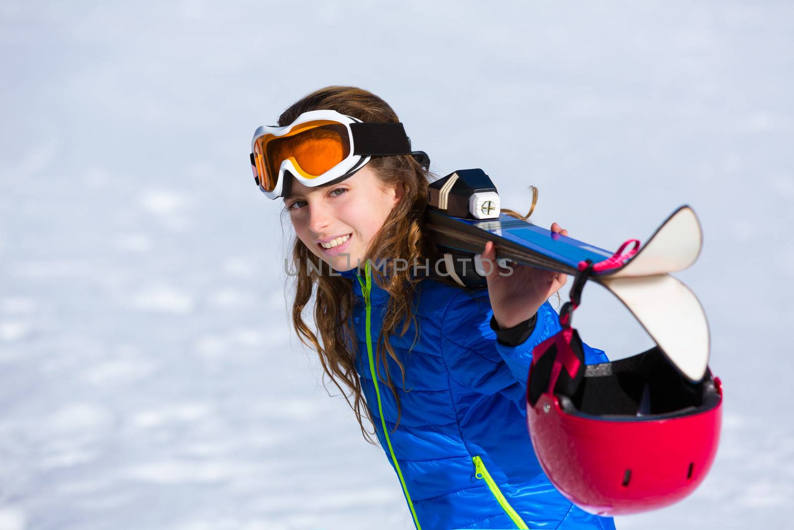 Kid girl winter snow holding ski equipment helmet goggles