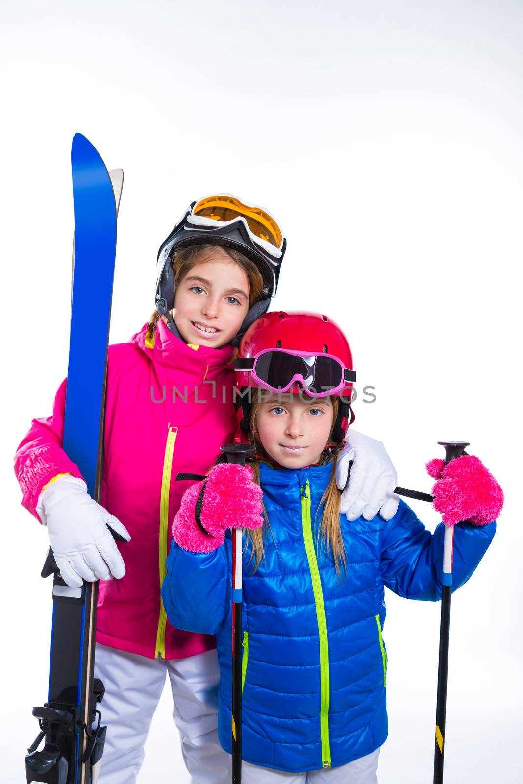 siters kid girls with ski poles helmet and goggles going to winter snow