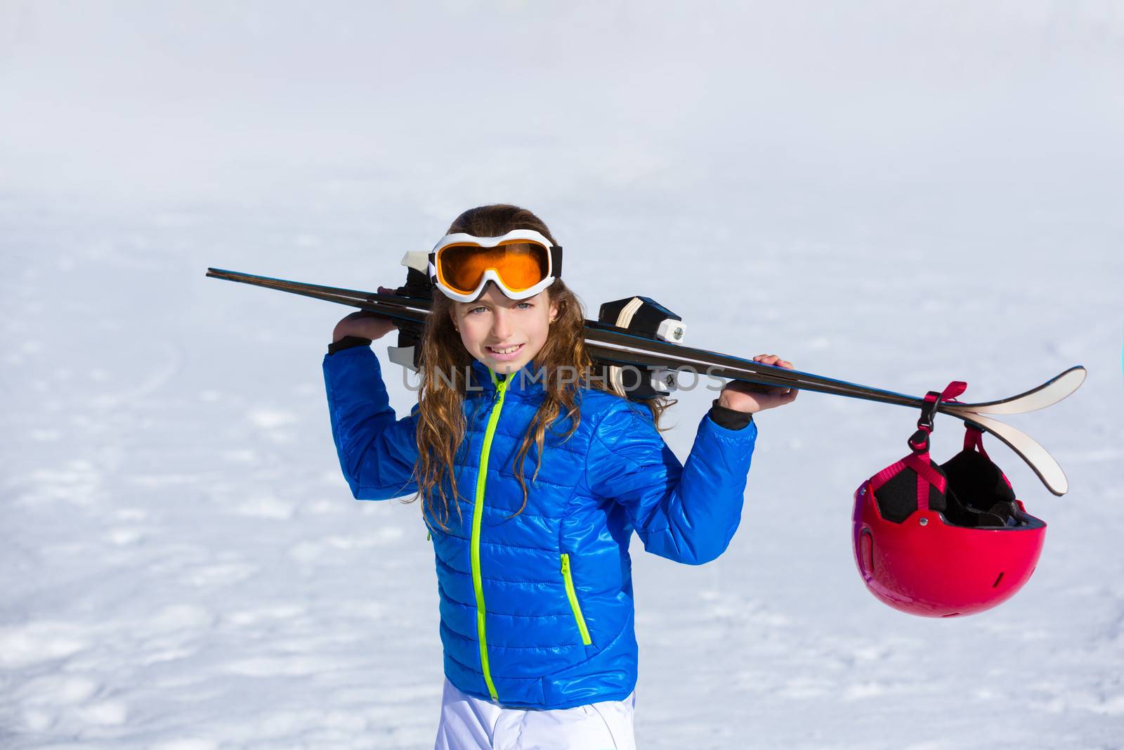 Kid girl winter snow holding ski equipment helmet goggles